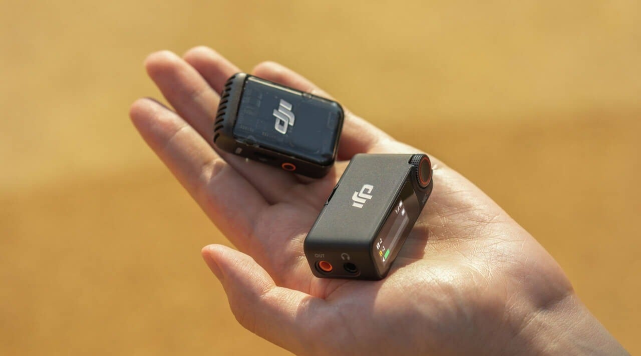 a person holds the DJI Mic 2 transmitter and receiver in the palm of their opened left hand