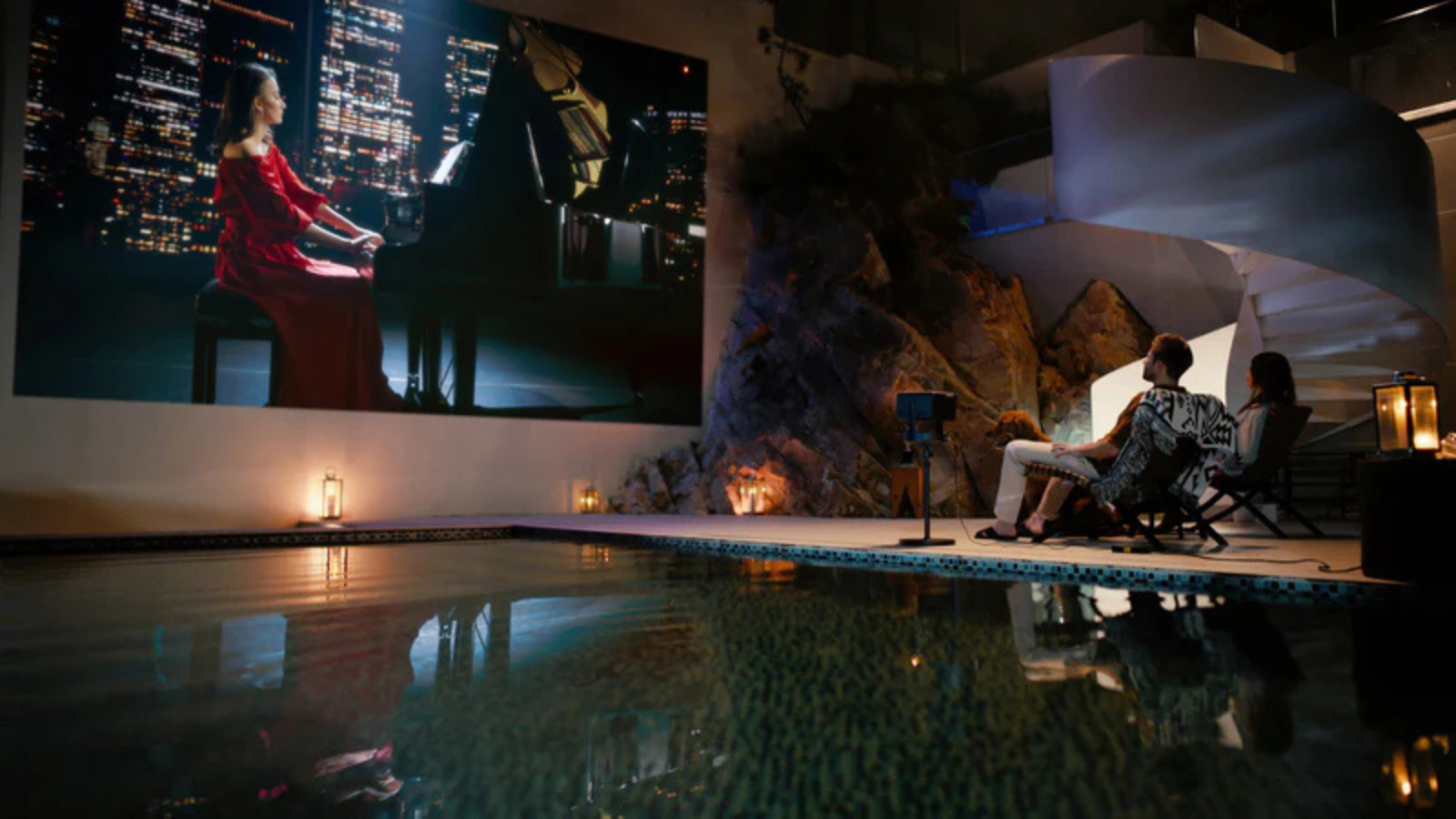 couple watching hisense c2 portable projector screen outdoors by pool