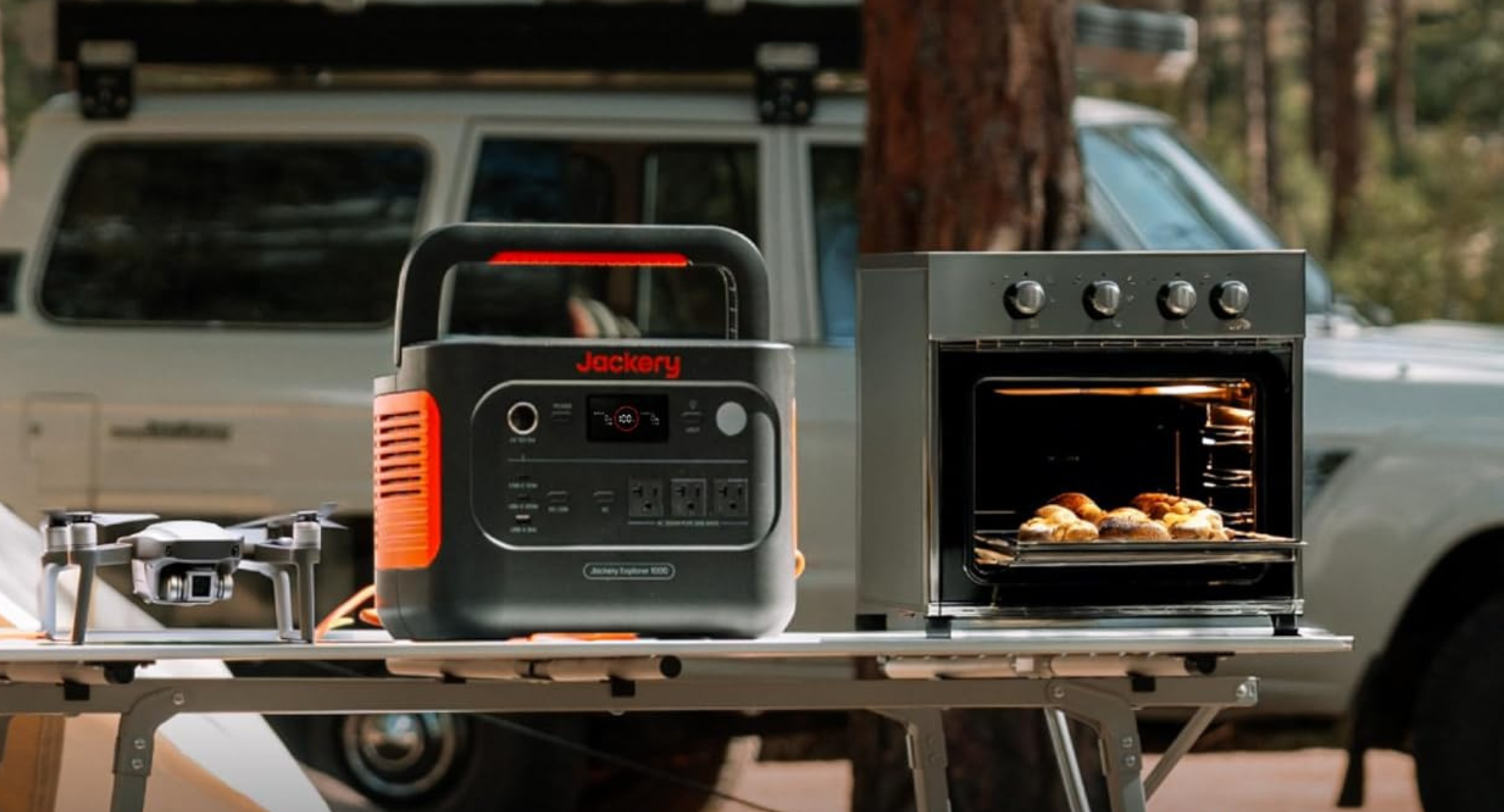The Jackery Explorer 1000 v2 sitting on a tabletop at a campsite.