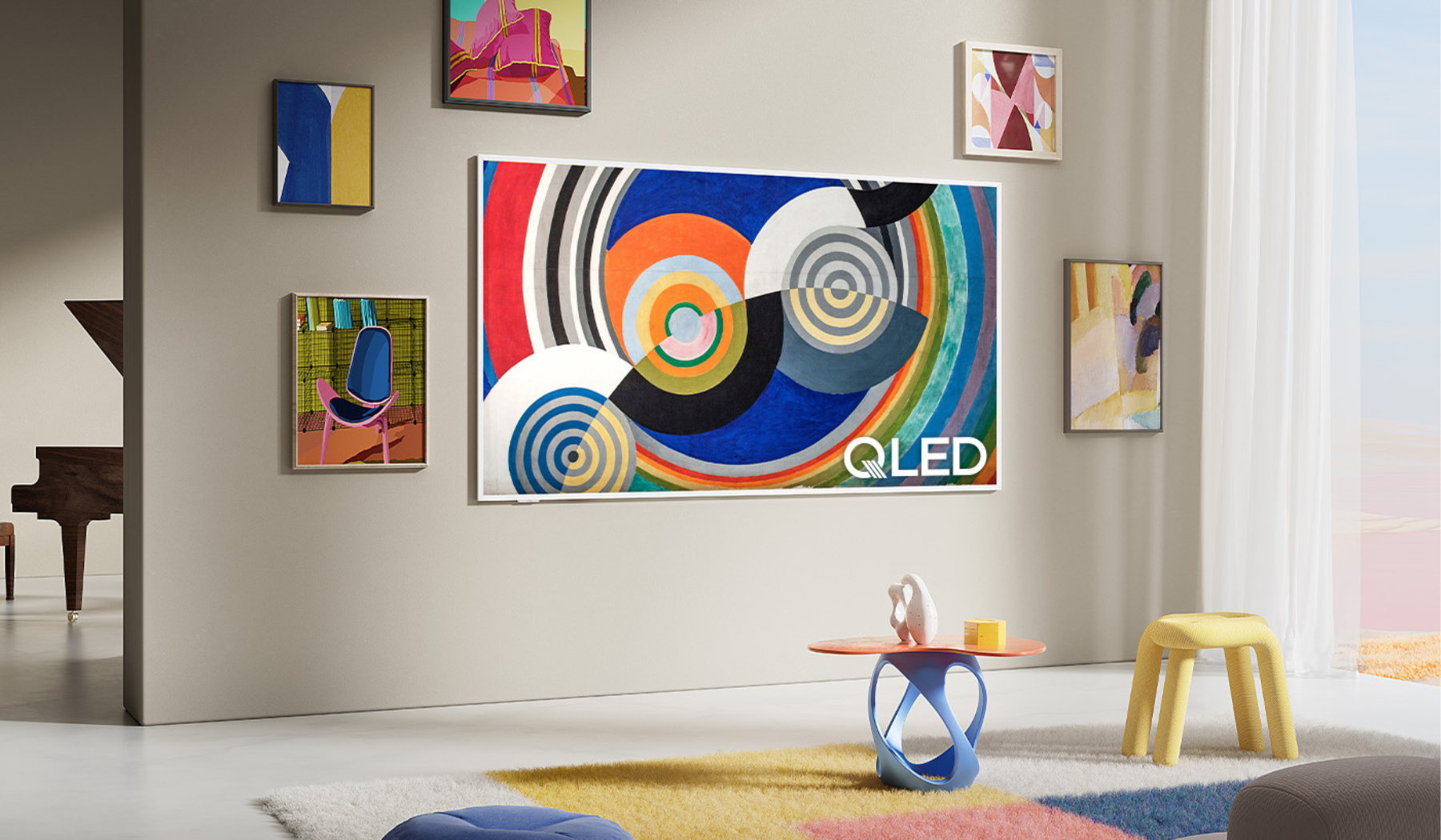 TCL NXTVISION TV hanging on wall surrounded by other paintings
