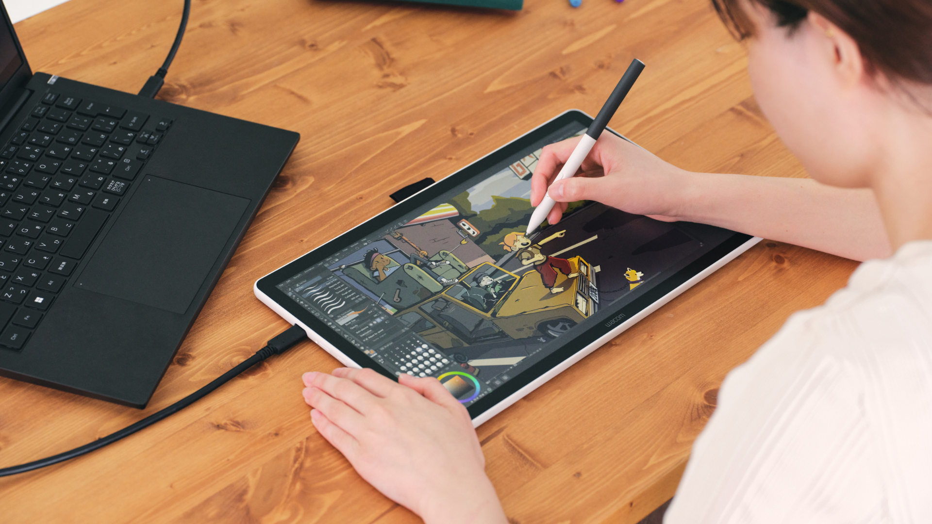 A person using a Wacom tablet to do illustration.