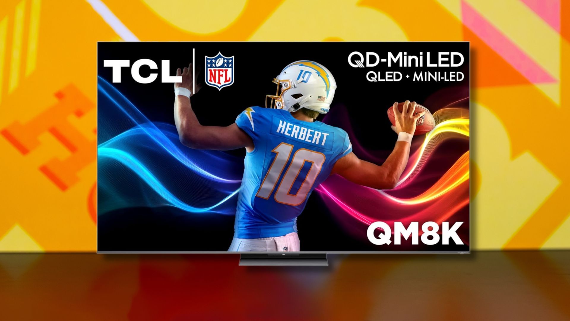 tcl 75-inch qm8k qd-mini led 4k tv against a yellow patterned background