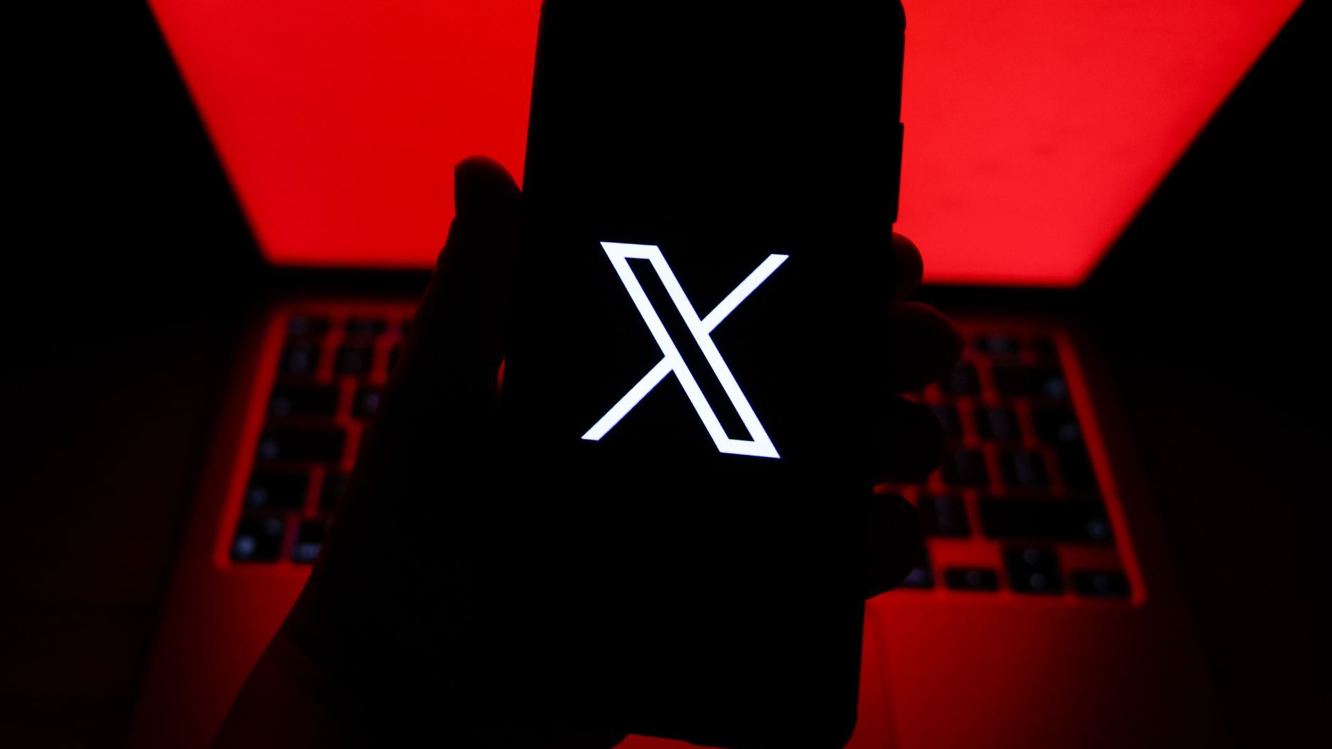 The X logo is seen on a smartphone.