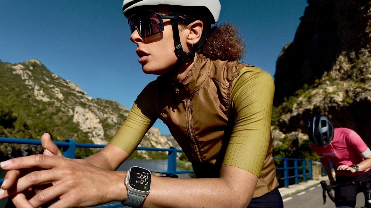 female cyclist wearing apple watch ultra 3 on mountain road