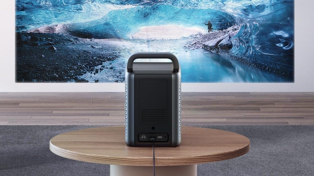 the nebula cosmo laser 4k projector displays a blue ocean scene on the wall in front of it