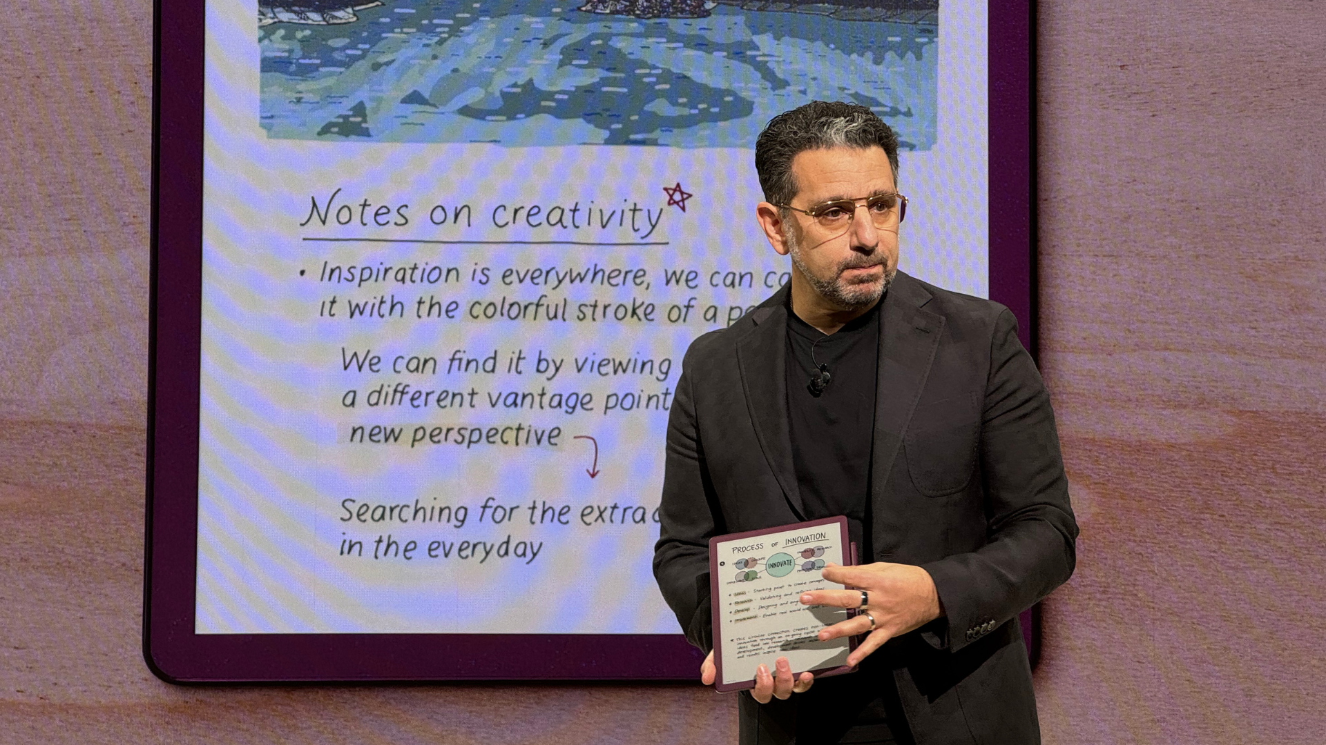 A person on a stage with the Kindle Scribe Colorsoft