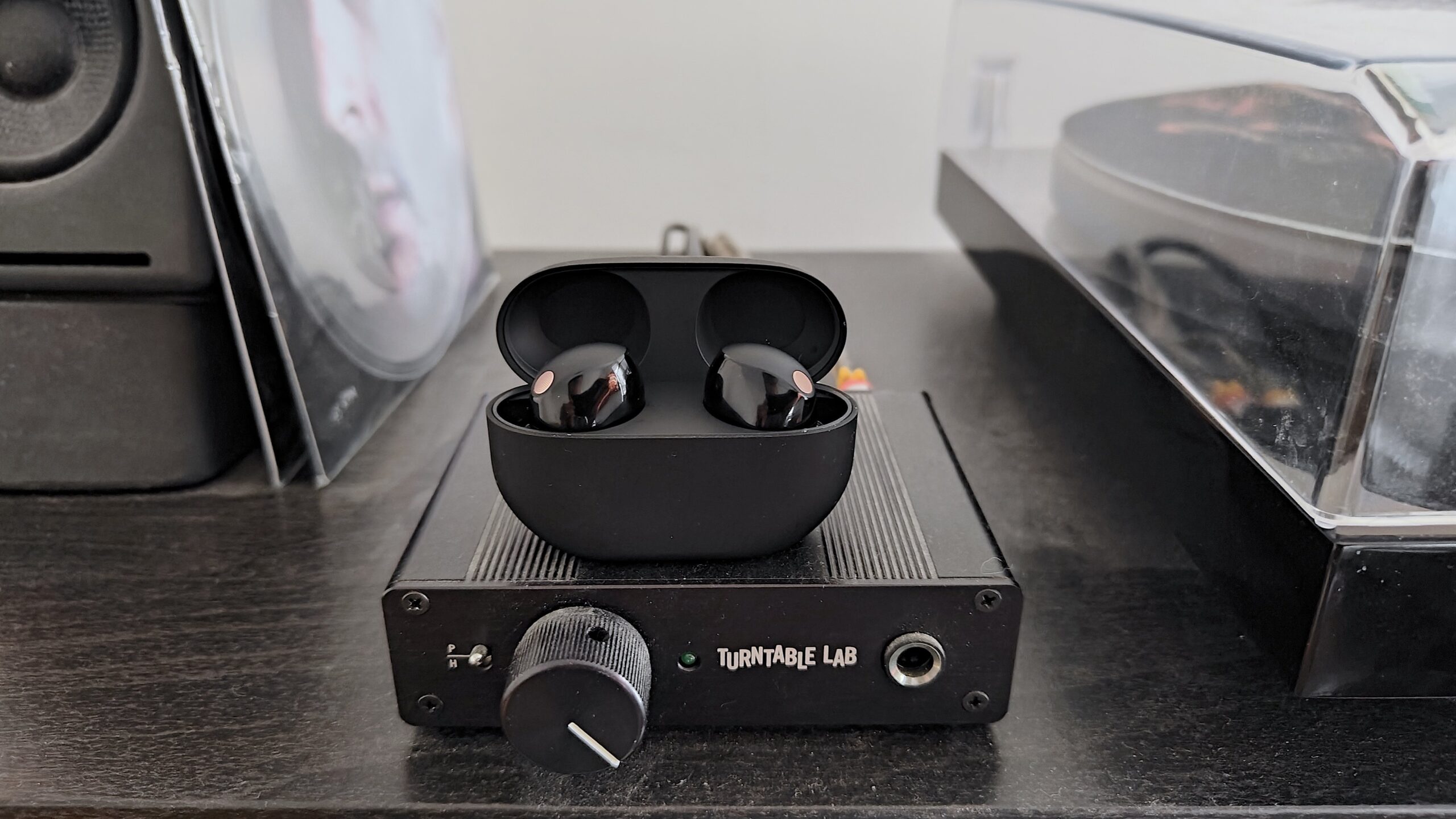 sony WF-1000XM5 earbuds sitting on mini turntable