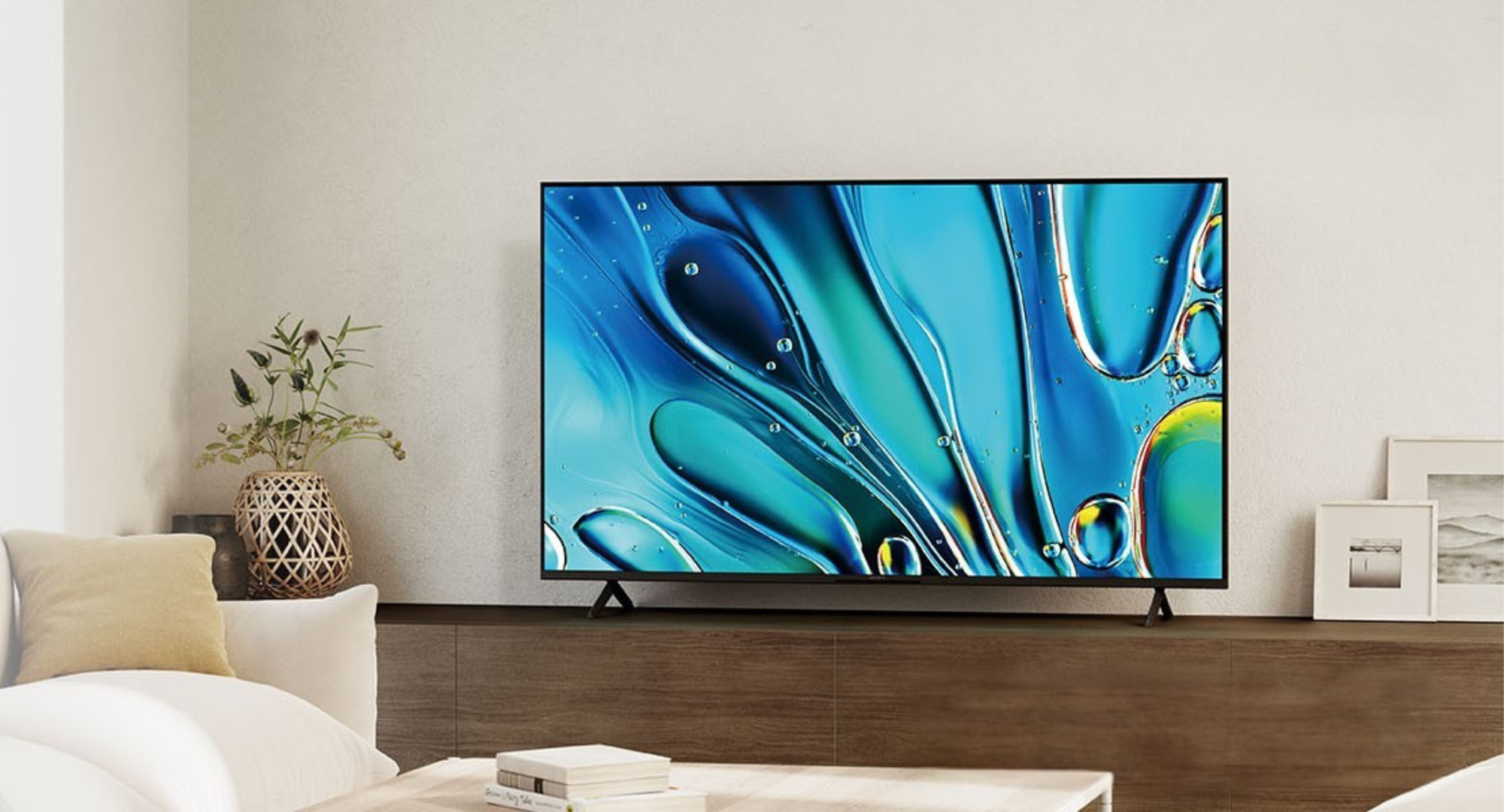The Sony Bravia 3 sitting on a brown sideboard.