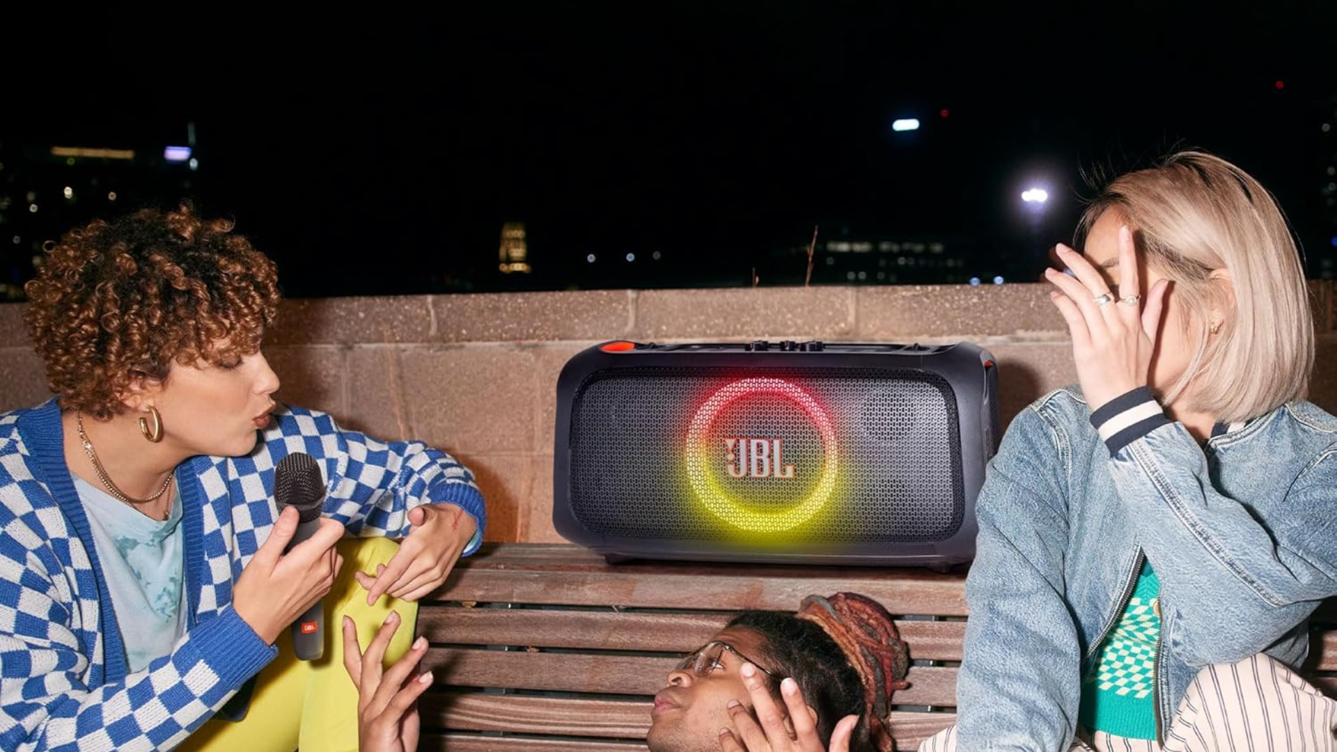 People hanging out around a JBL speaker.