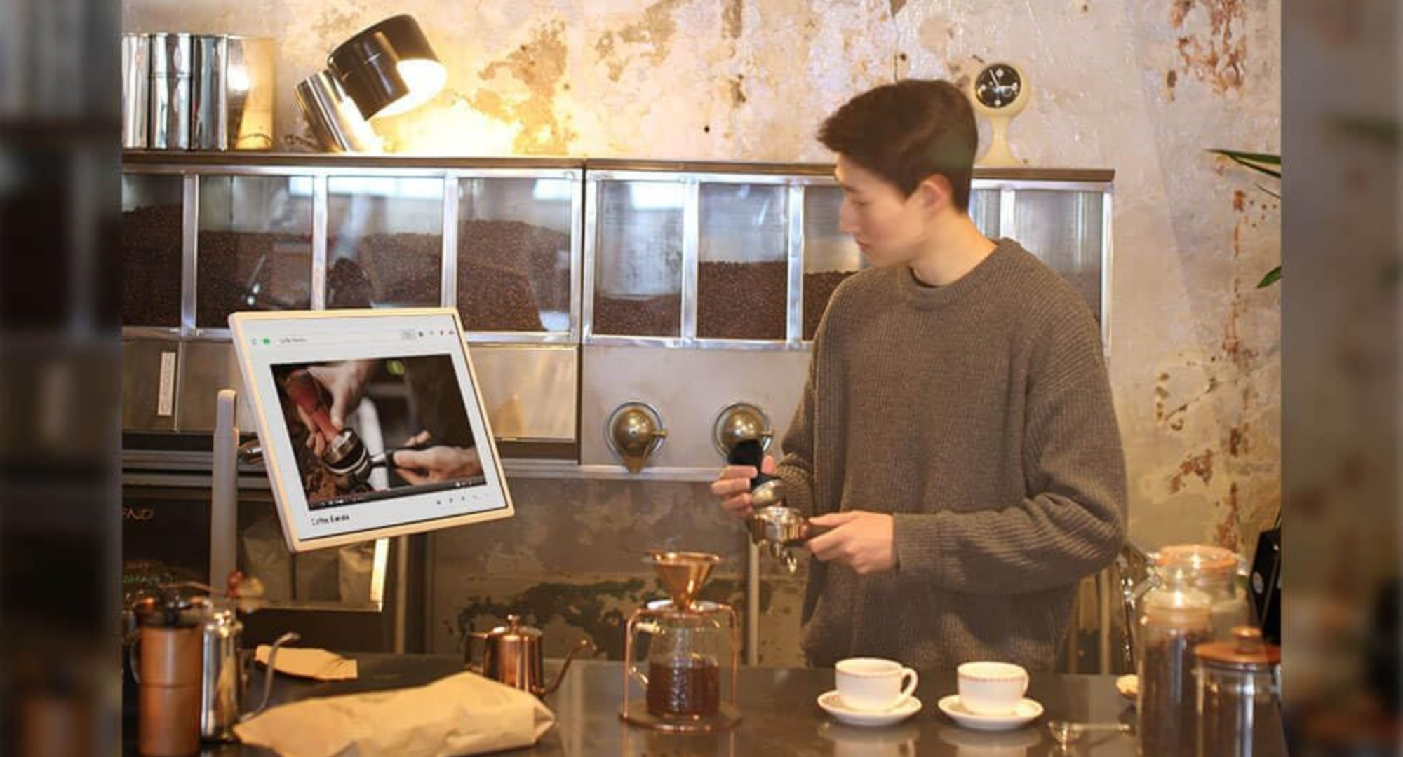 A person looking at the LG StanbyMe while cooking.