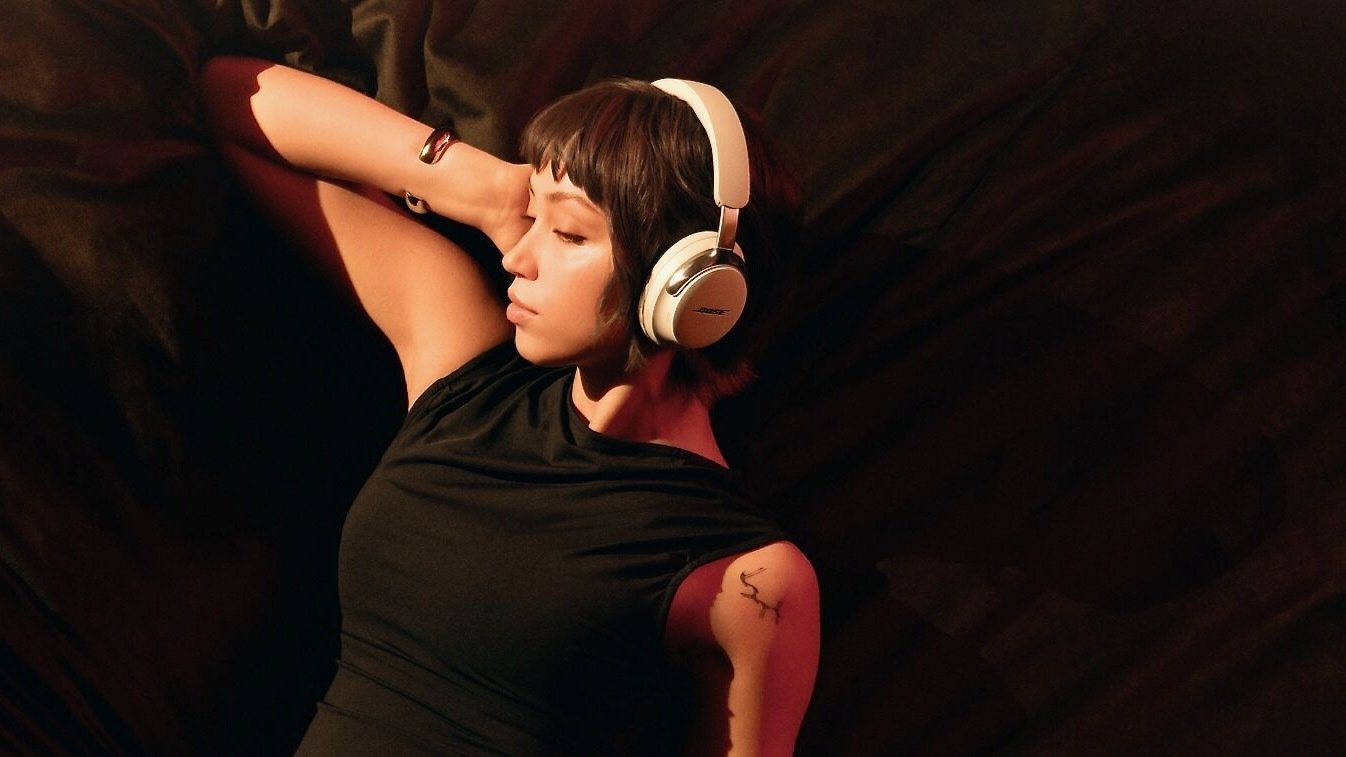 woman with bangs wearing bose quietcomfort ultra 2nd gen headphones