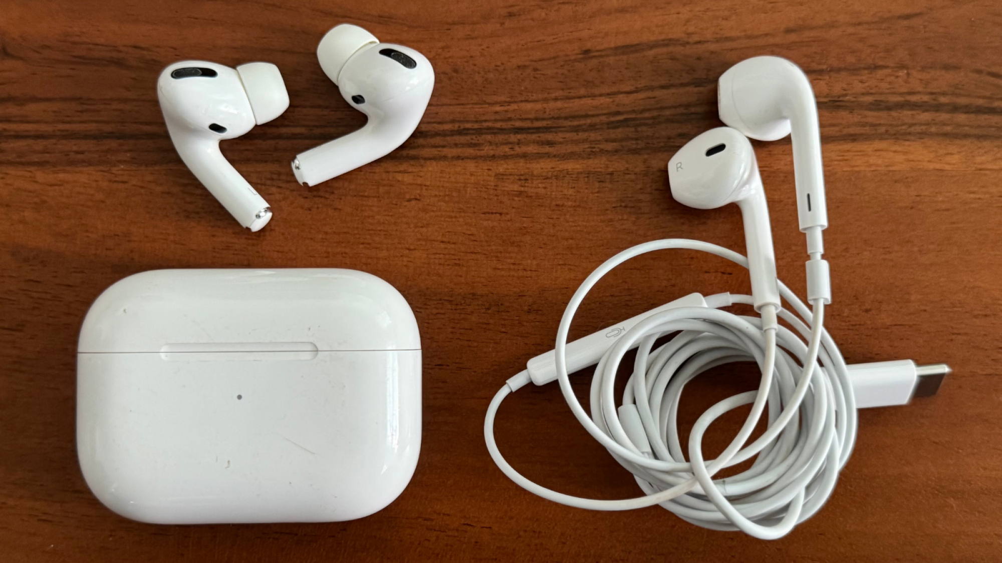 the first-generation airpods pro next to a pair of earpods