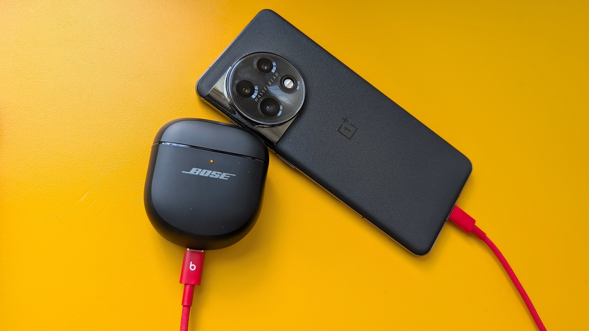 phone and earbuds connected by charging cable