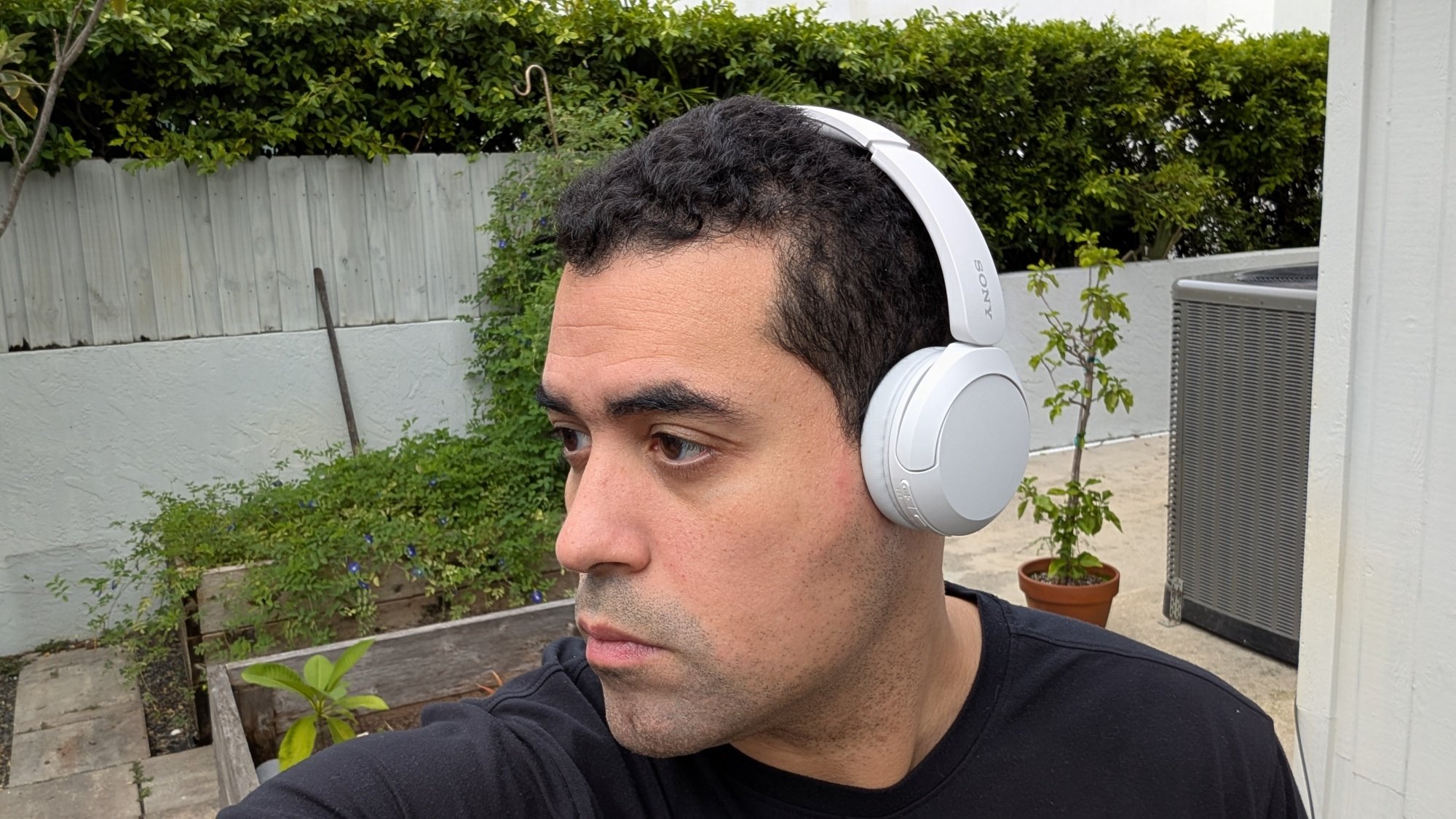 author wearing Sony WH-CH520 headphones outside