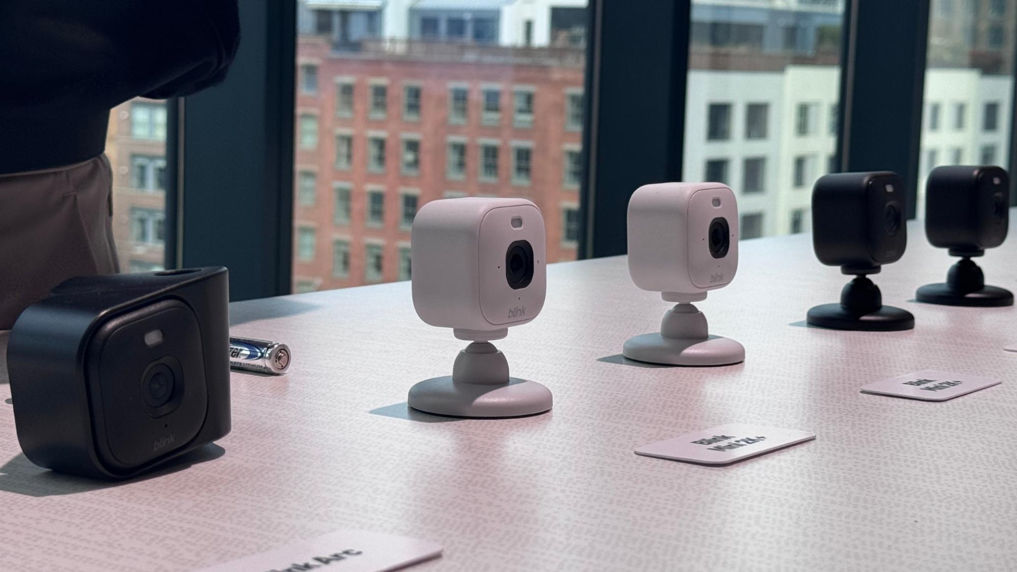 Five Blink cameras on a table.