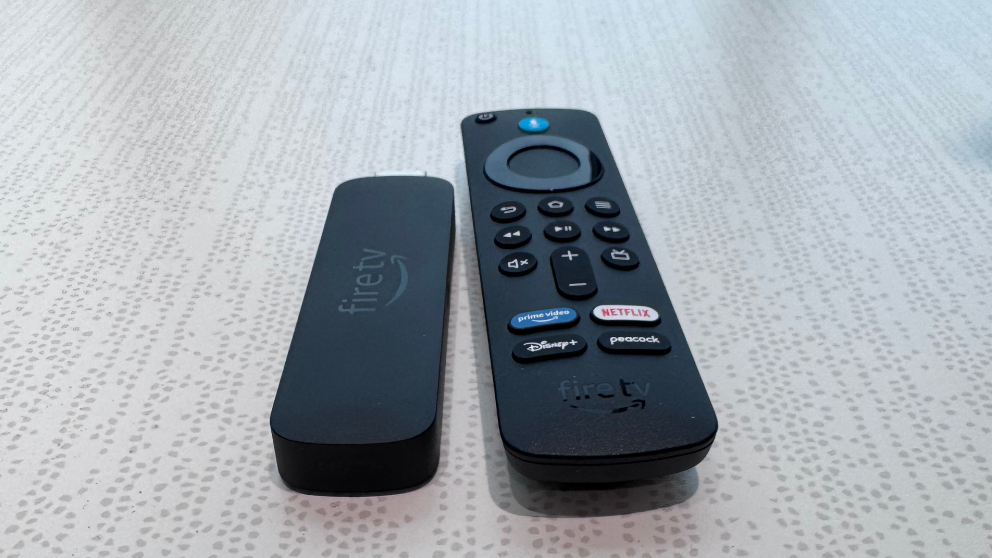 A Amazon Fire TV 4K Select Streaming Stick on a table