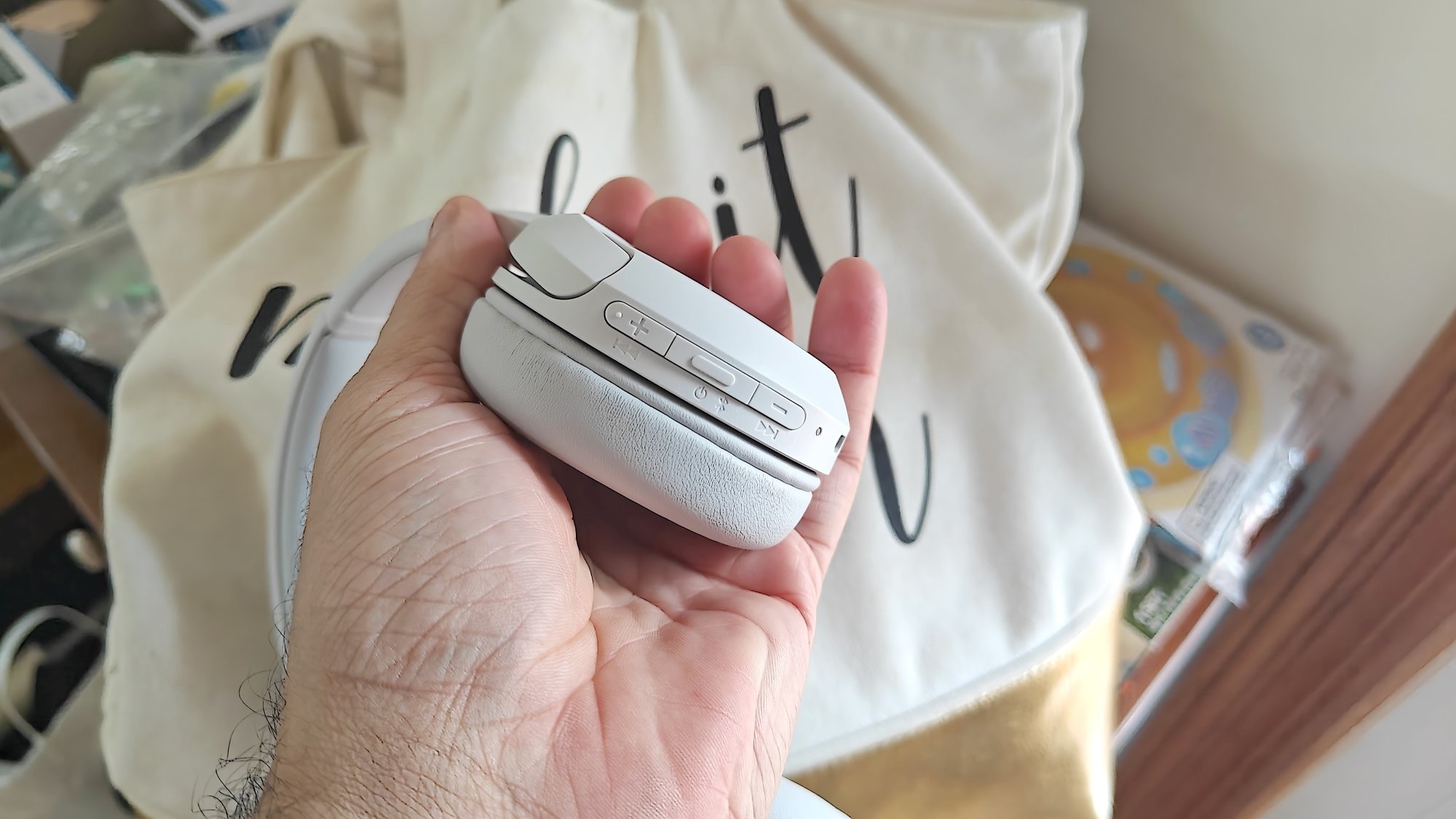 Sony WH-CH520 held in hand with controls visible