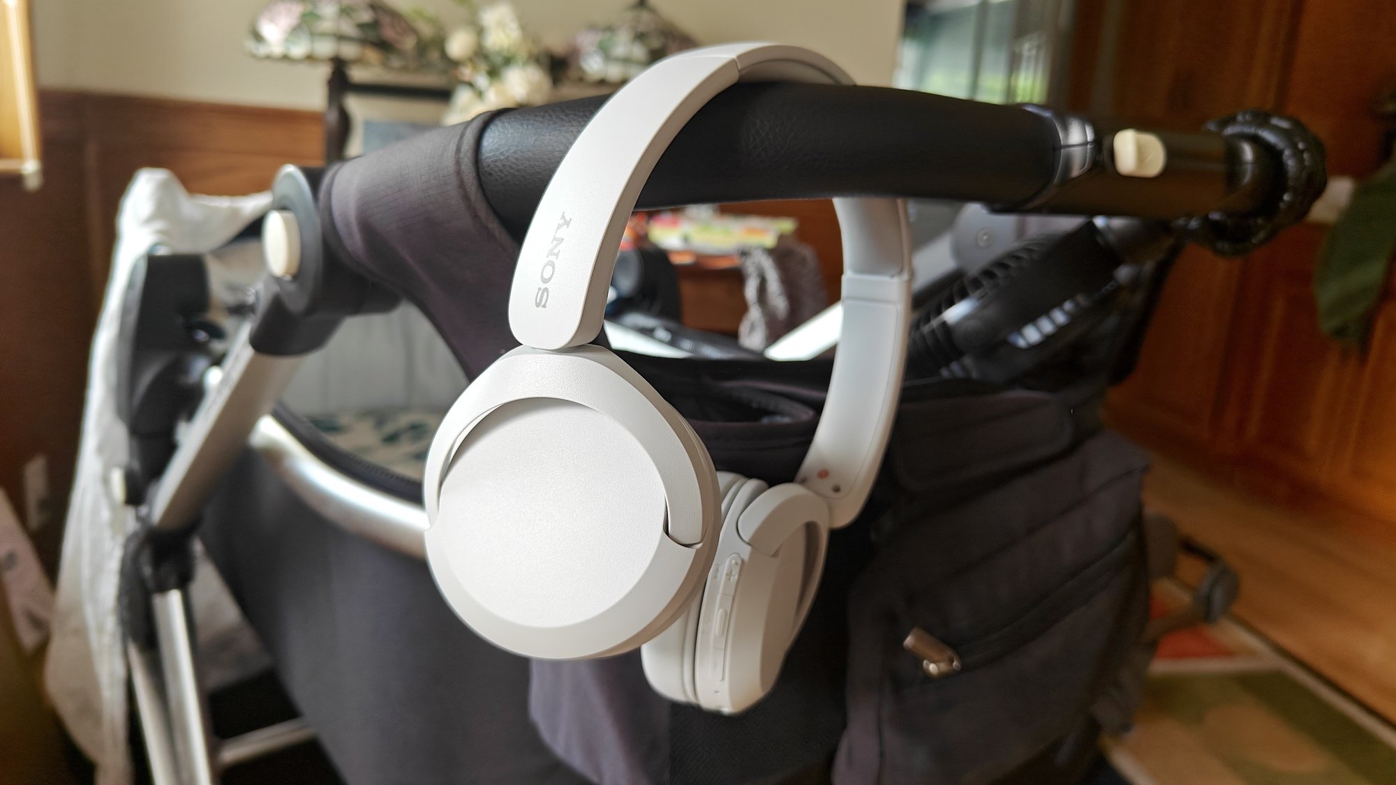 Sony WH-CH520 headphones hanging on stroller handle