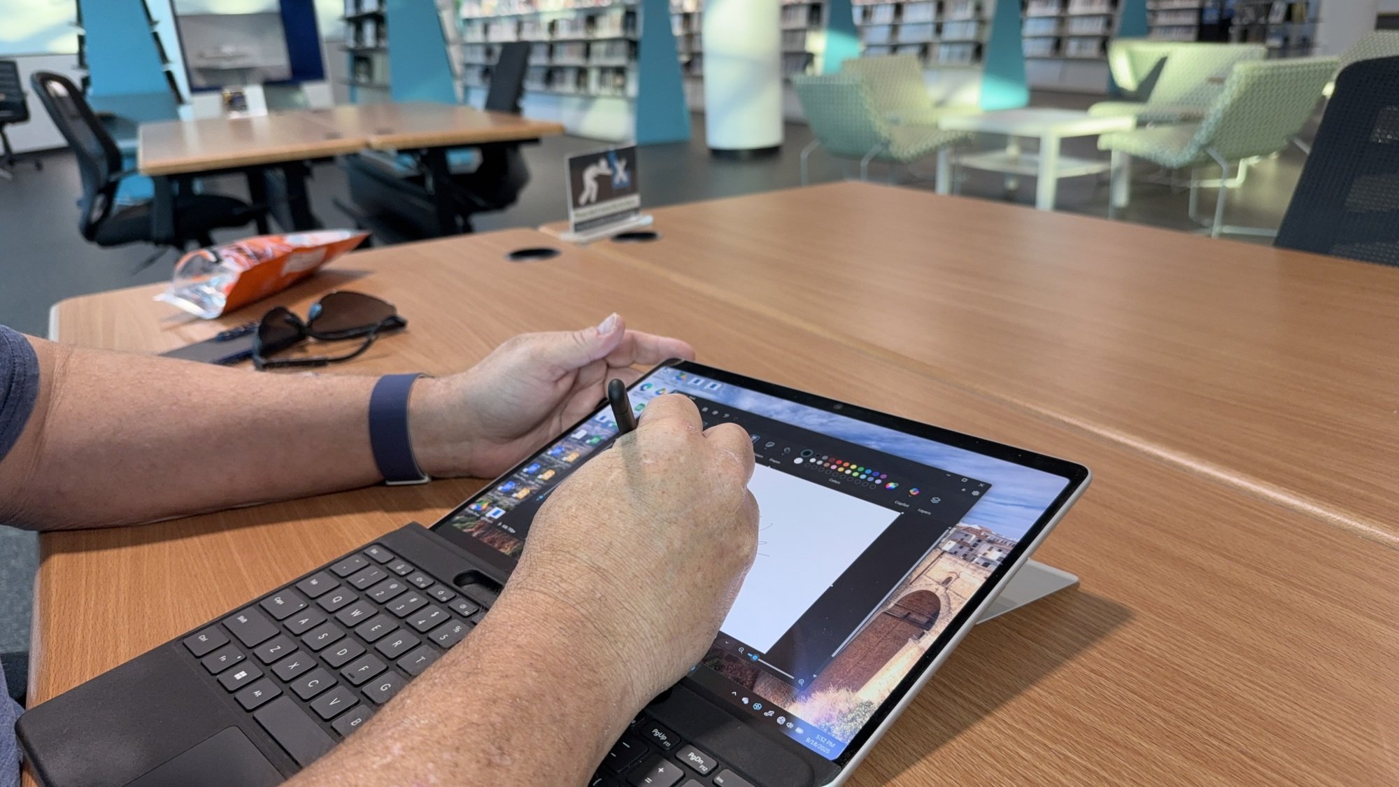 man using microsoft surface pro 13 laptop as drawing tablet
