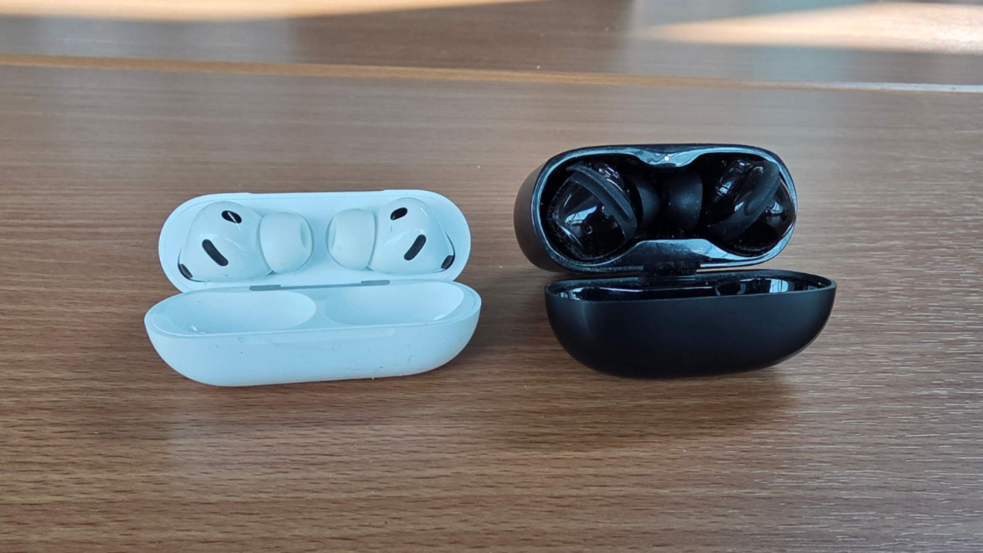 pair of airpods pro next to pair of bose quietcomfort ultra