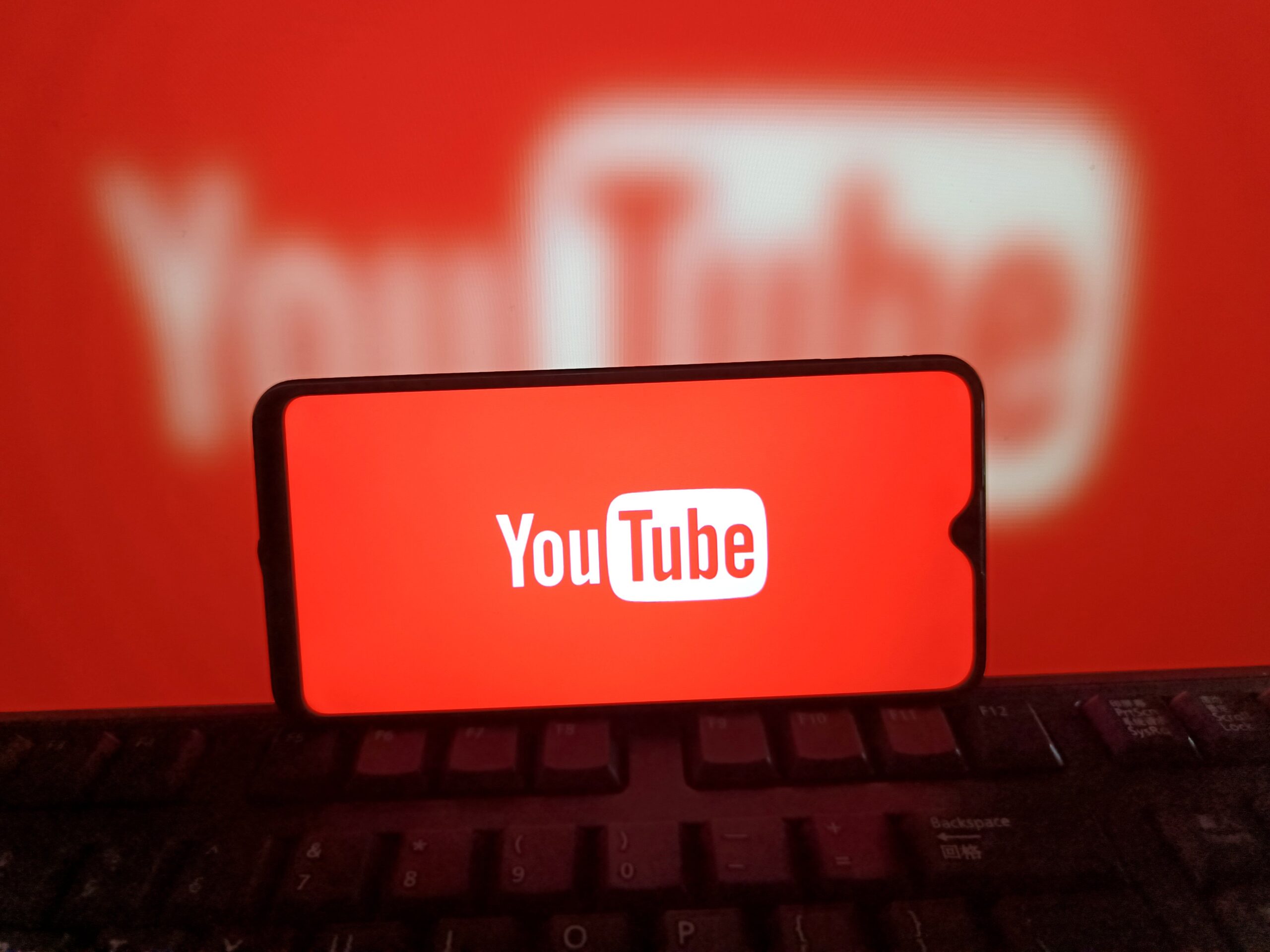A phone showing a red YouTube logo.