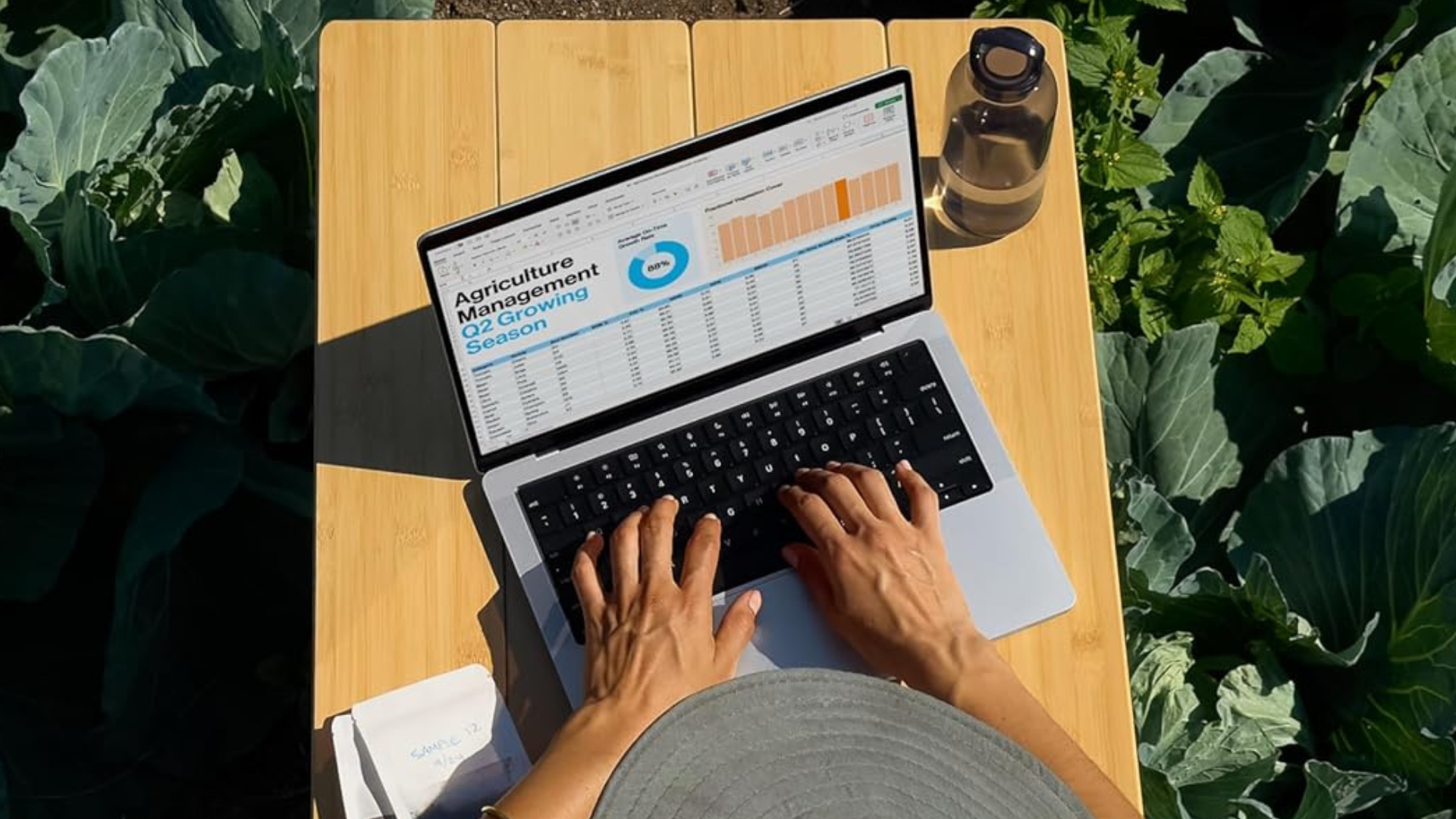 A person using a MacBook Pro outdoors