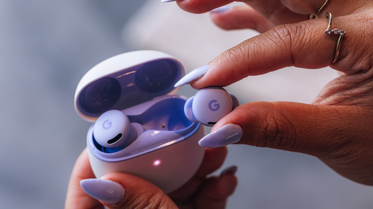 woman with purple fingernails pulling pixel buds 2a earbuds out of charging case