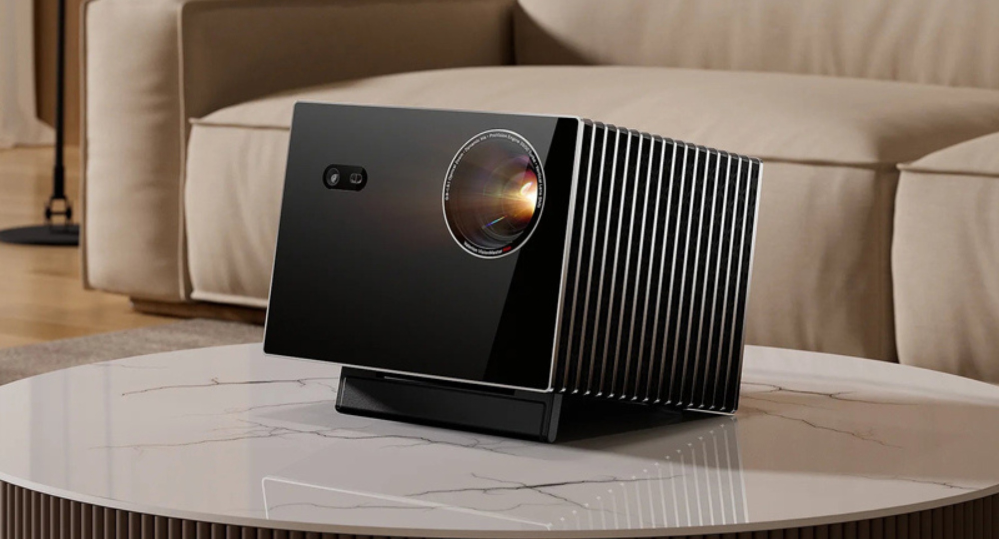 The VisionMaster Max projector sitting on a white marble coffee table.