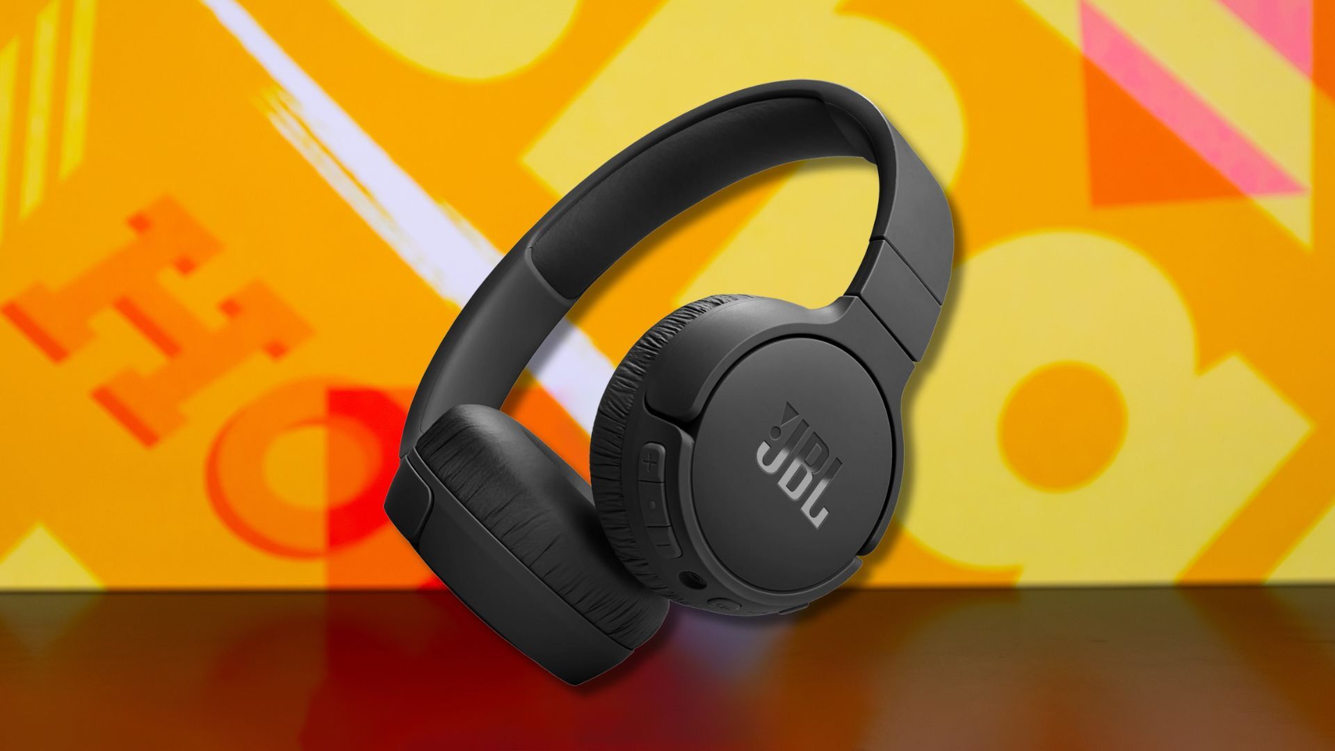 jbl tune 670nc headphones against a yellow patterned background