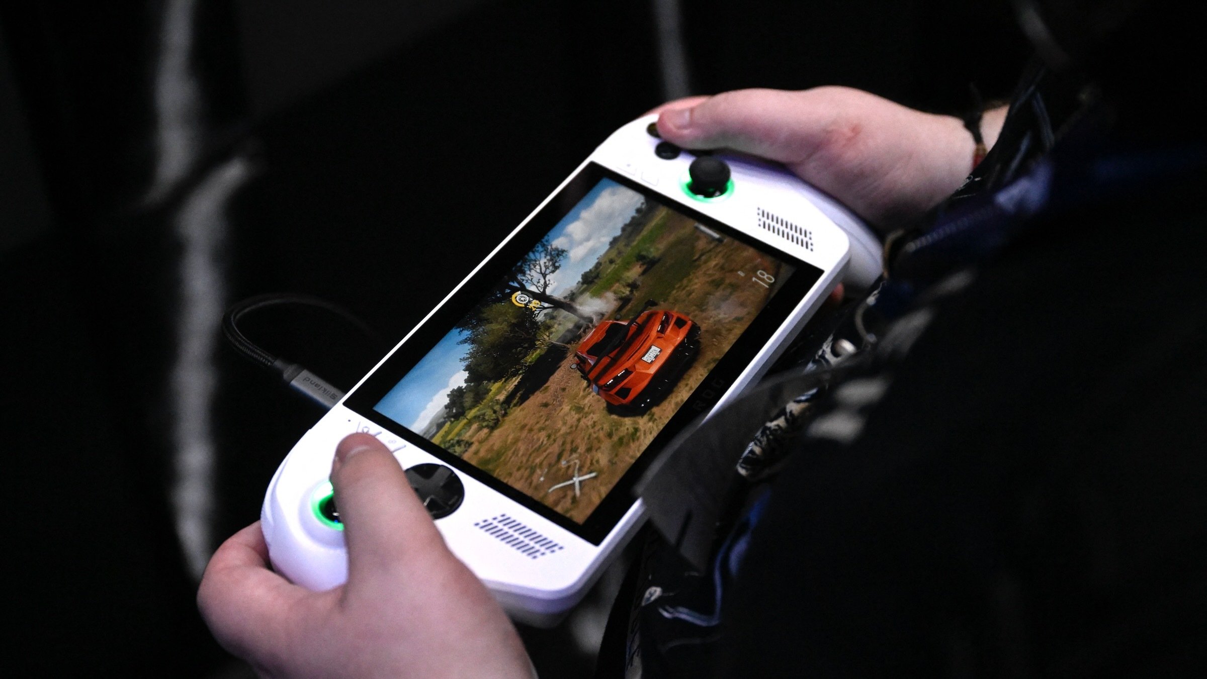 gamer plays the Forza Horizon 5 video game on a ROG Xbox Ally X