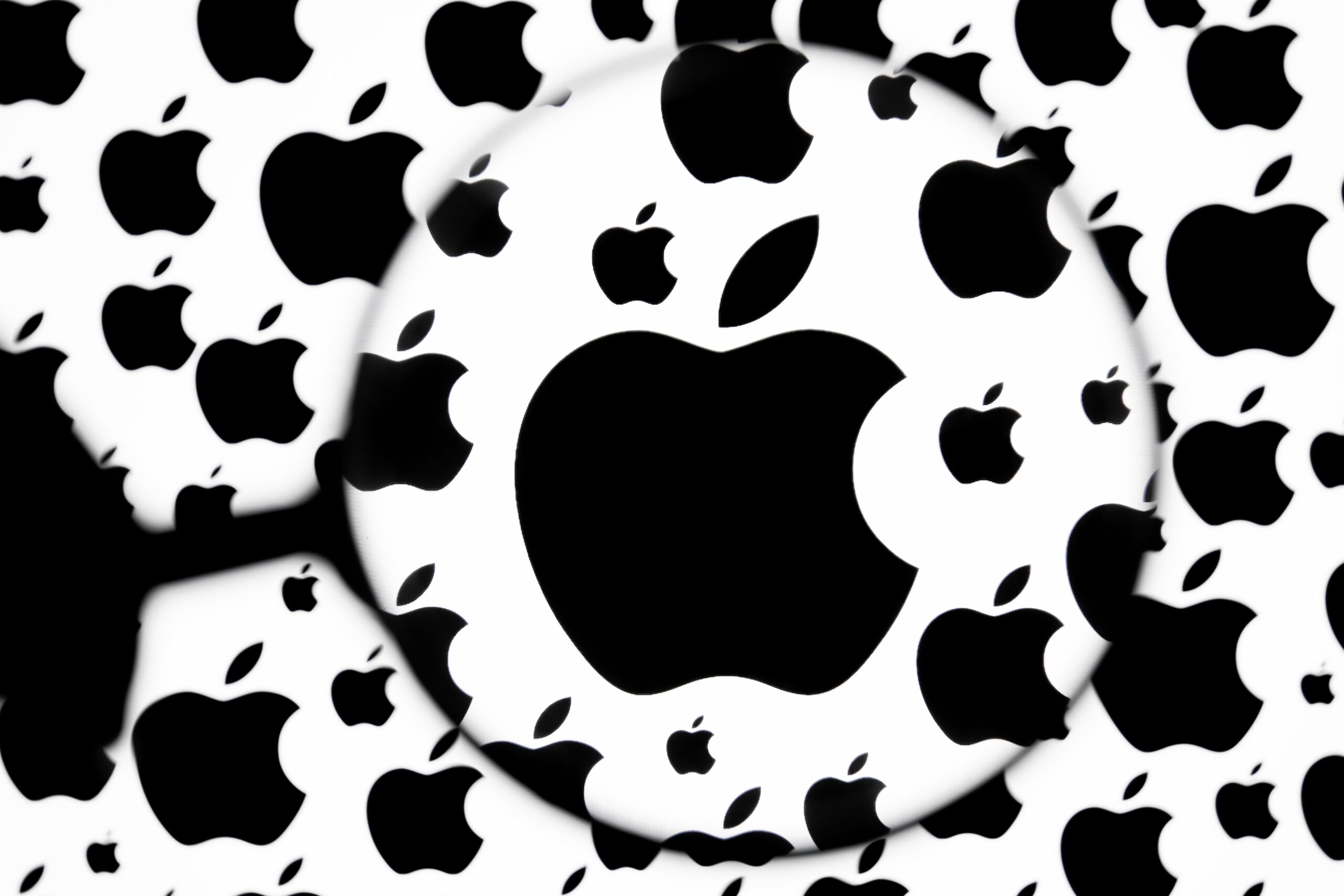 Apple logo under magnifying glass