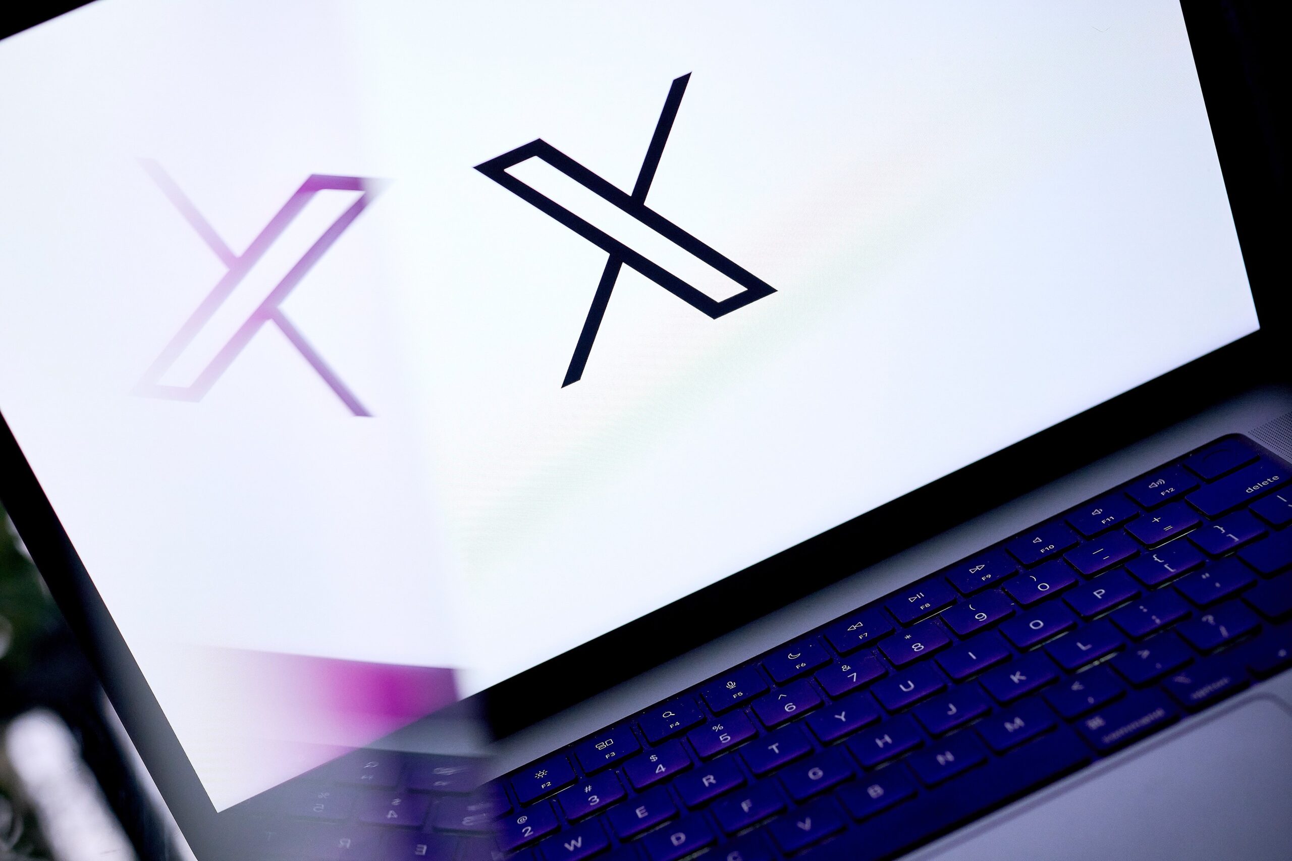 X logo on laptop