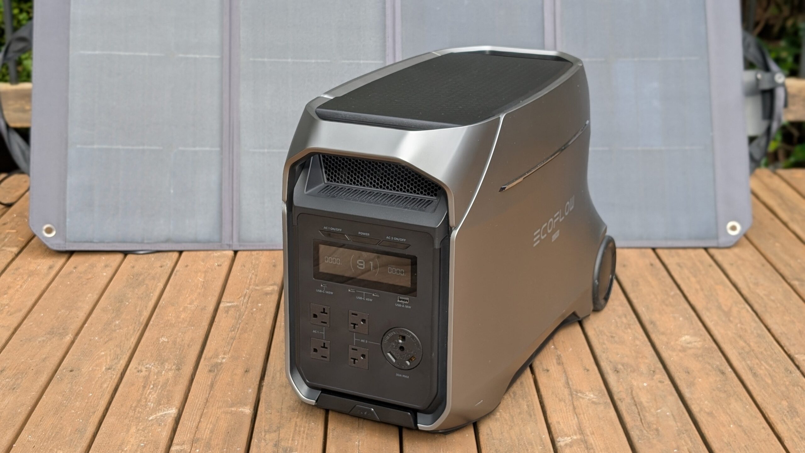 the ecoflow delta 3 ultra plus in front of a solar panel on a deck