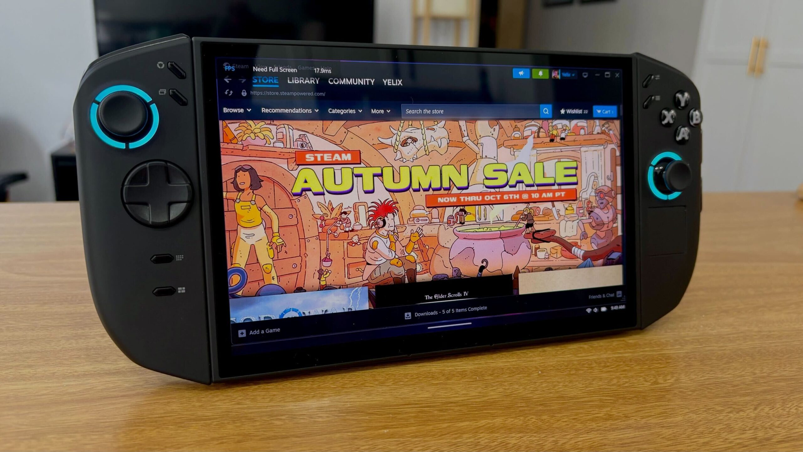 Lenovo Legion Go 2 sitting on a wooden countertop with store on screen