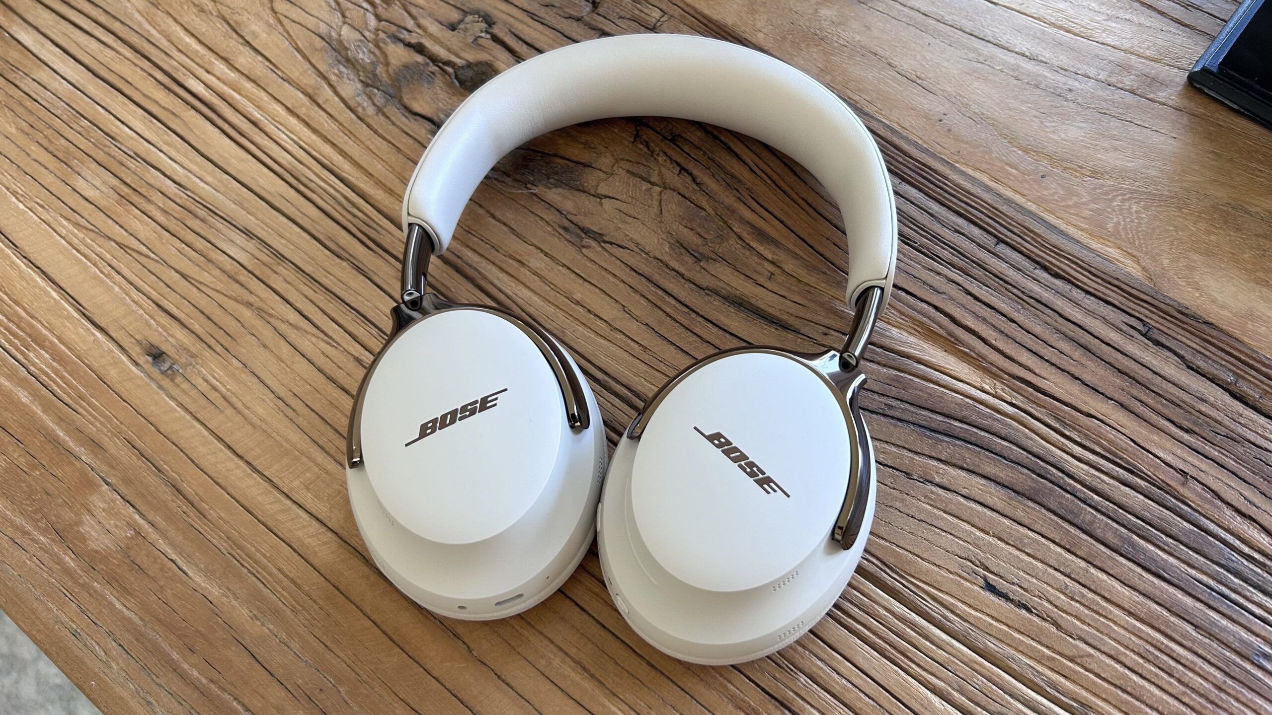 bose qc ultra second gen headphones on wooden table top