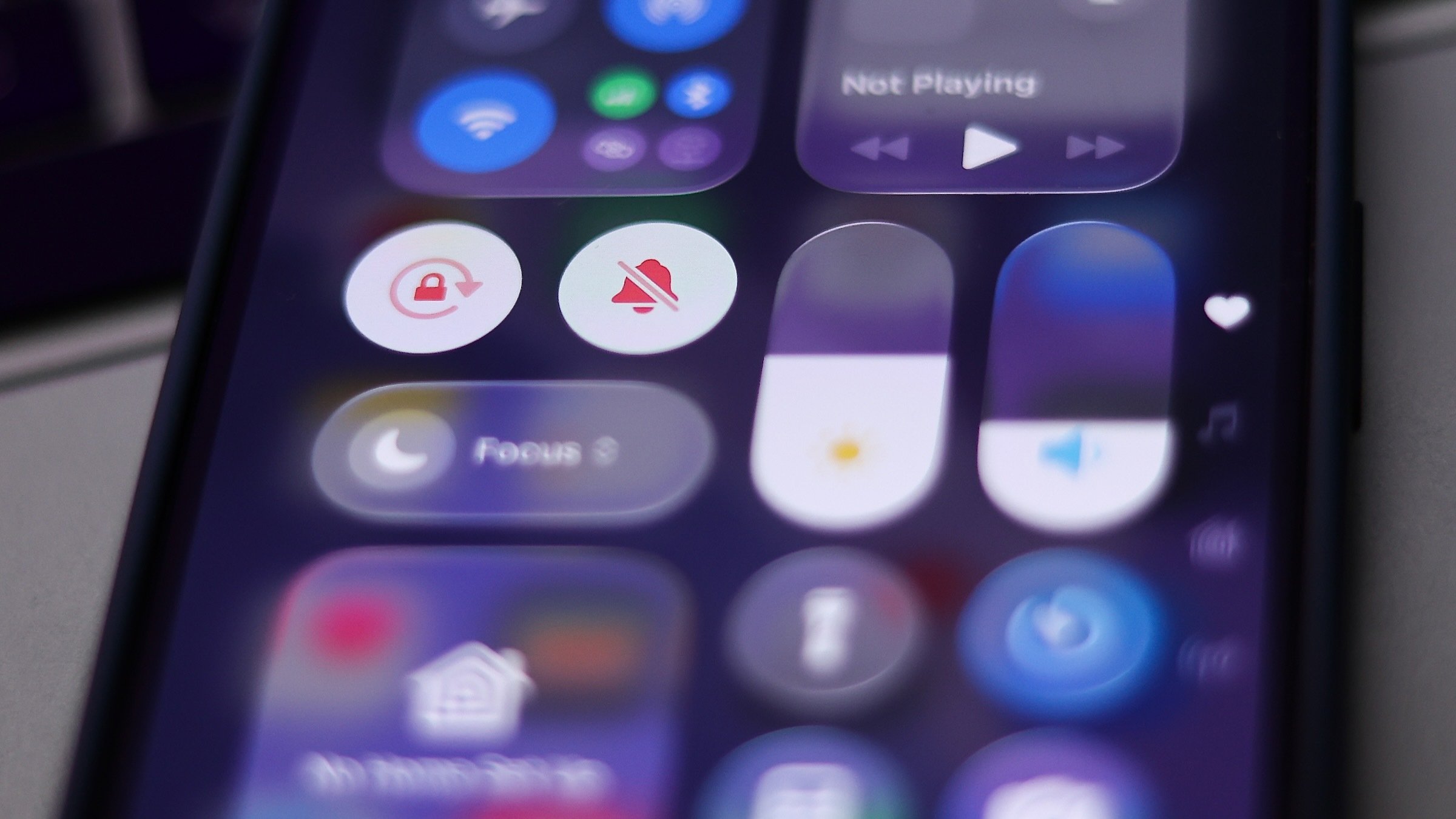 iOS 26 icons are seen displayed in liquid glass on iphone running ios 26