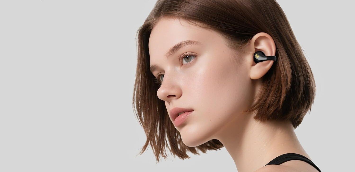 the monster open-ear earbuds on a person
