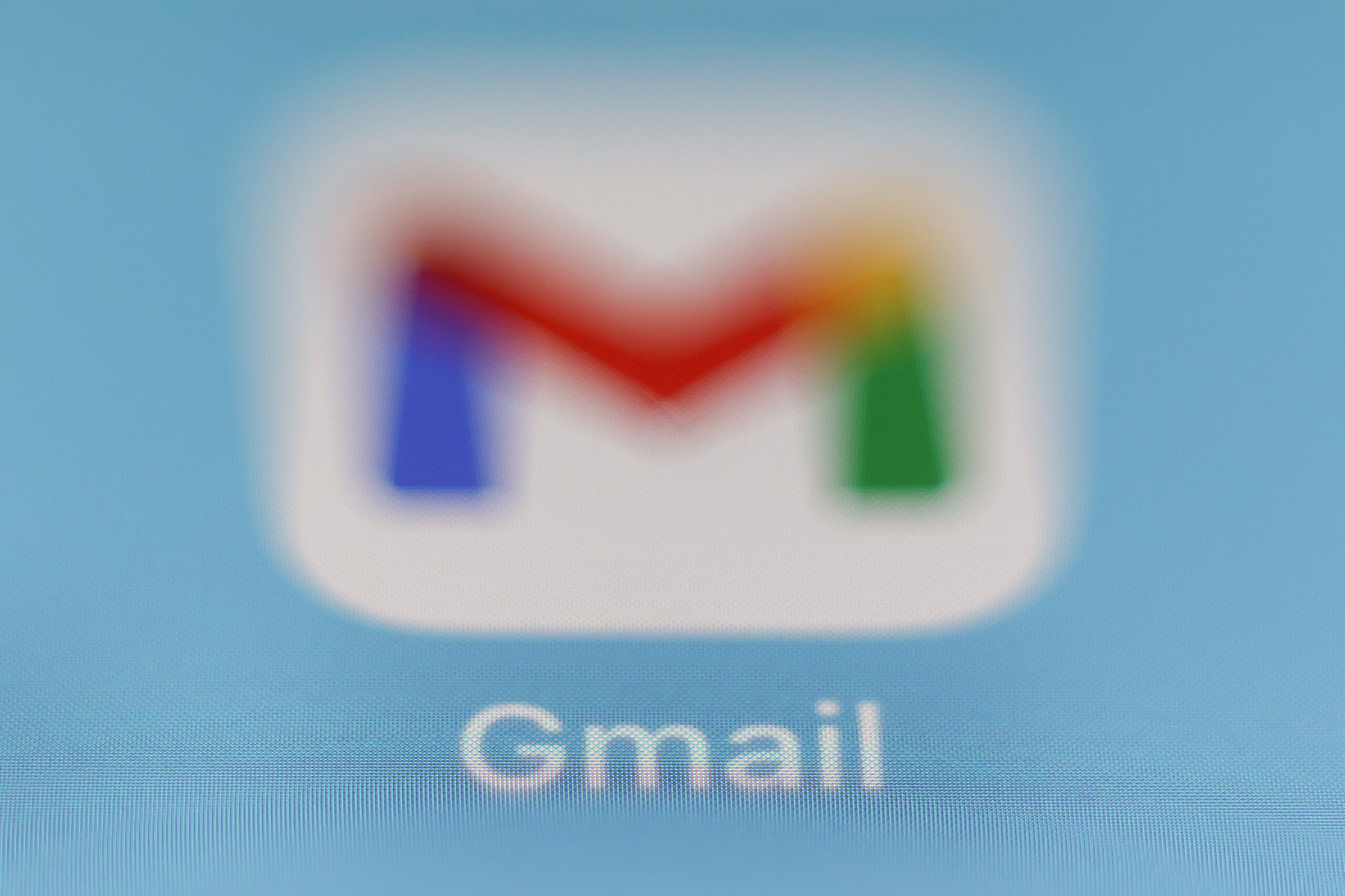 gmail logo, blurred, against a blue background