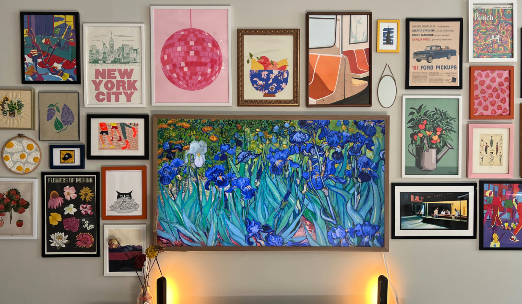 Hisense Canvas TV hanging on wall amongst framed art