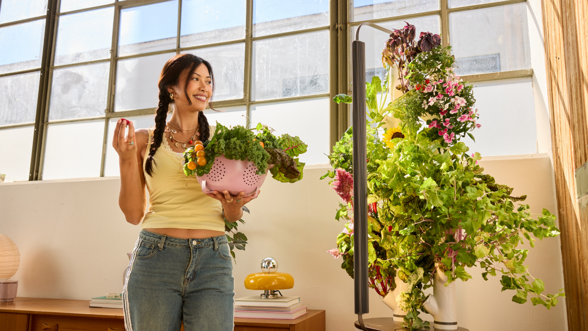 A person standing next to a Gardyn Studio 2