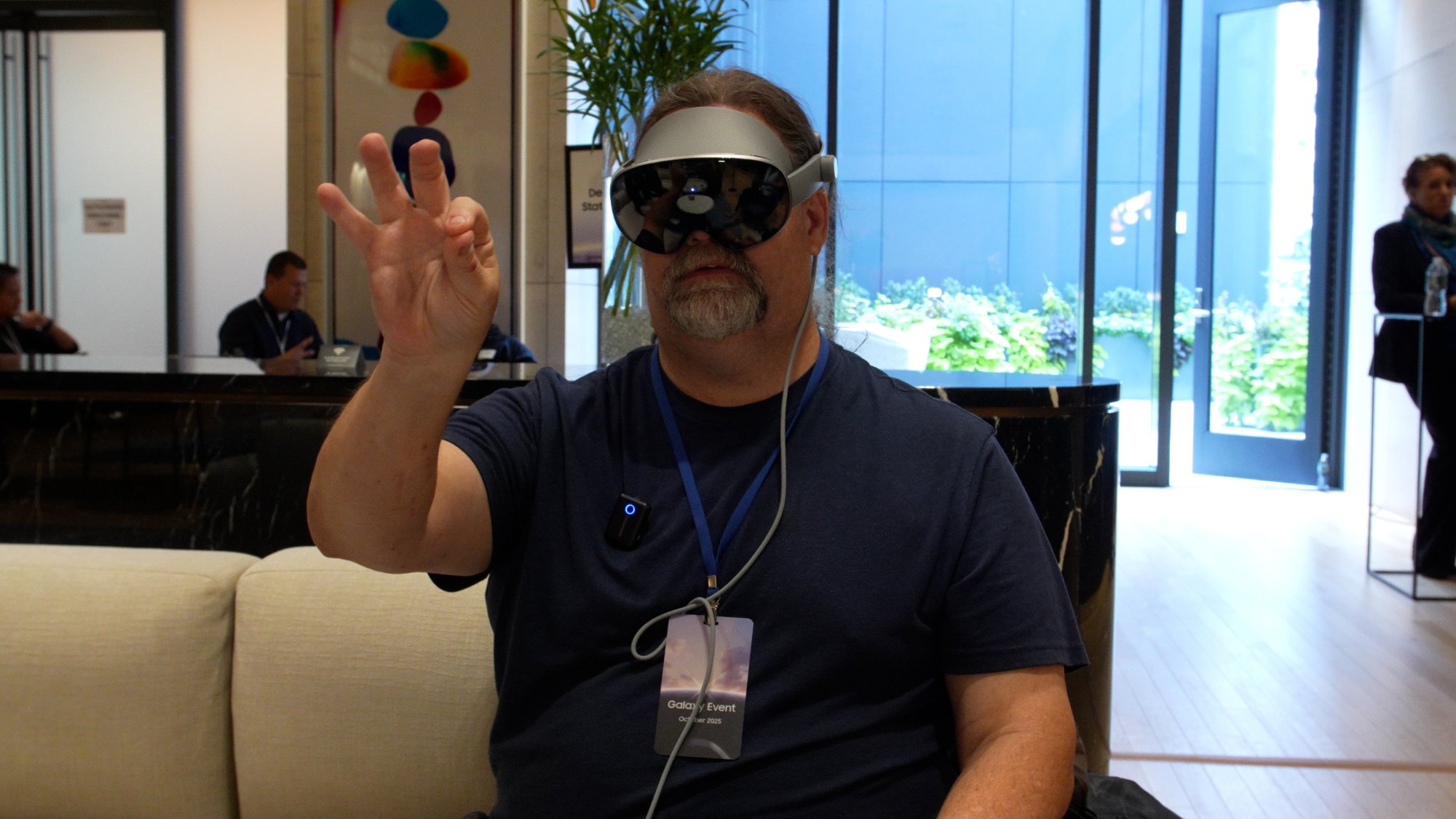 journalist adam doud wearing galaxy xr headset and using hand controls