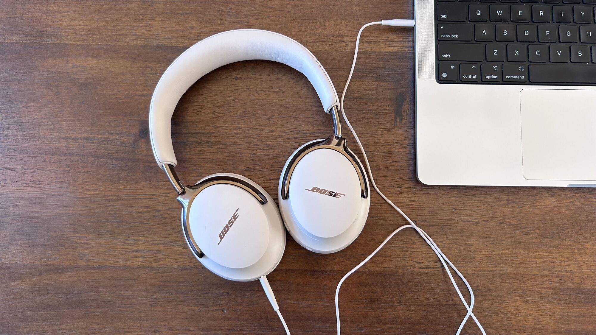 bose headphones plugged into laptop with aux cord