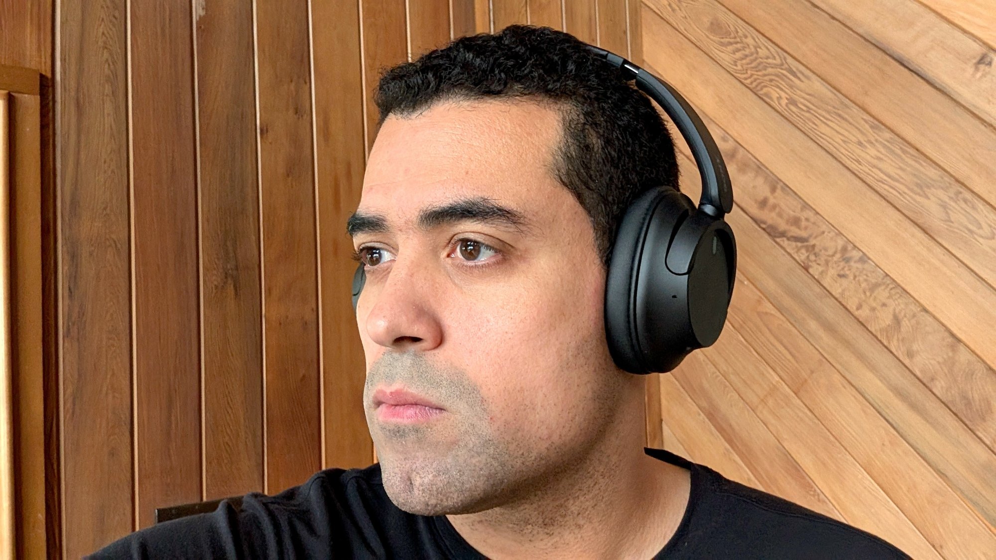 Reviewer Alex Bracetti wearing the Sony WH-CH720N headphones in black