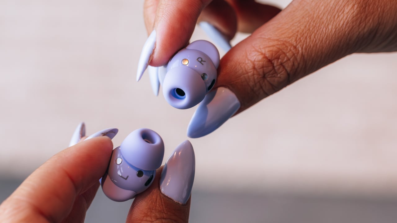 woman with purple nails holds pixel buds 2a in a matching lilac color