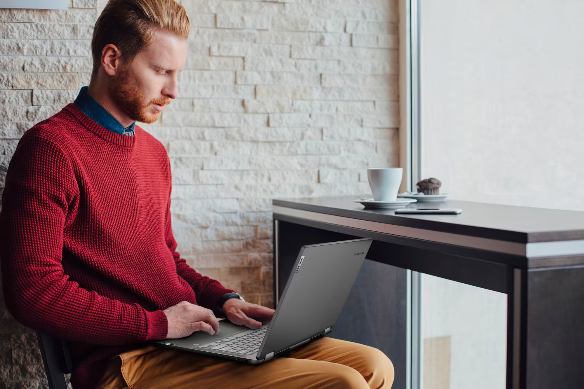 a man typing on the lenovo flex 5i chromebook plus
