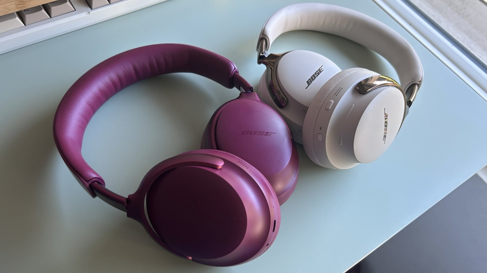 bose headphones on desk side by side