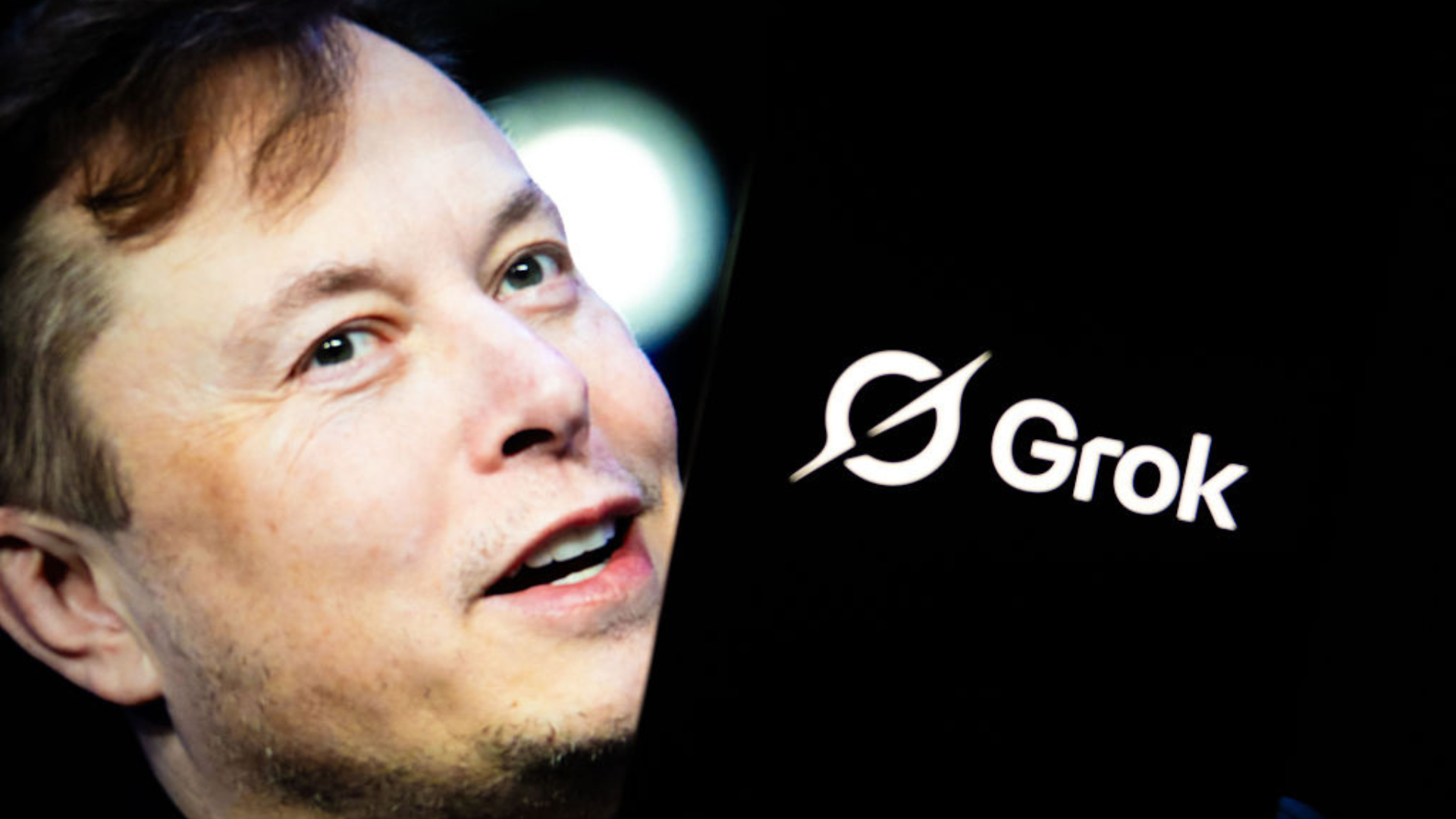 'Grok' logo is seen displayed on a mobile phone screen in front of a picture of Elon Musk.