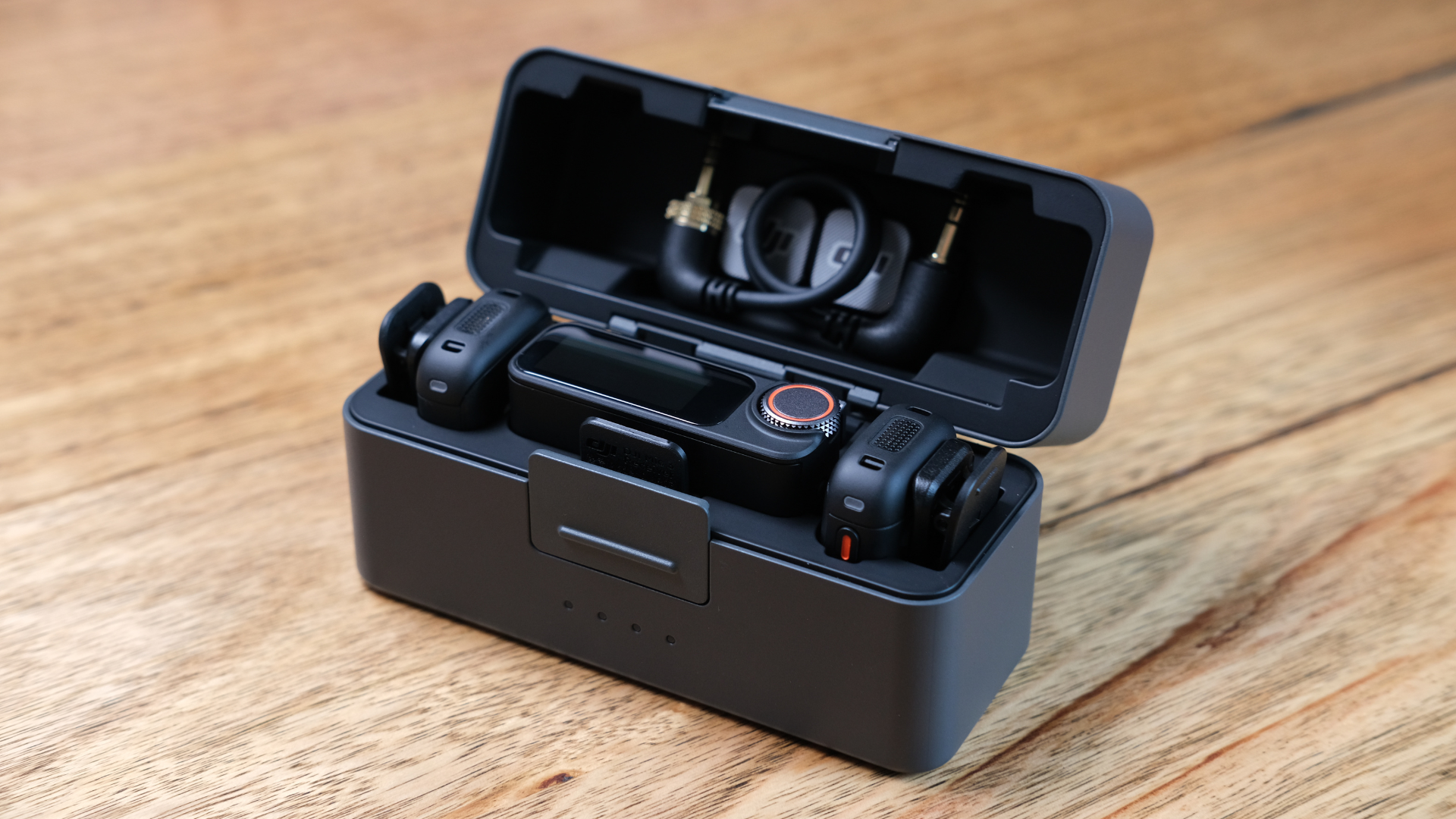 The DJI Mic 3 and its accessories in its charging case.