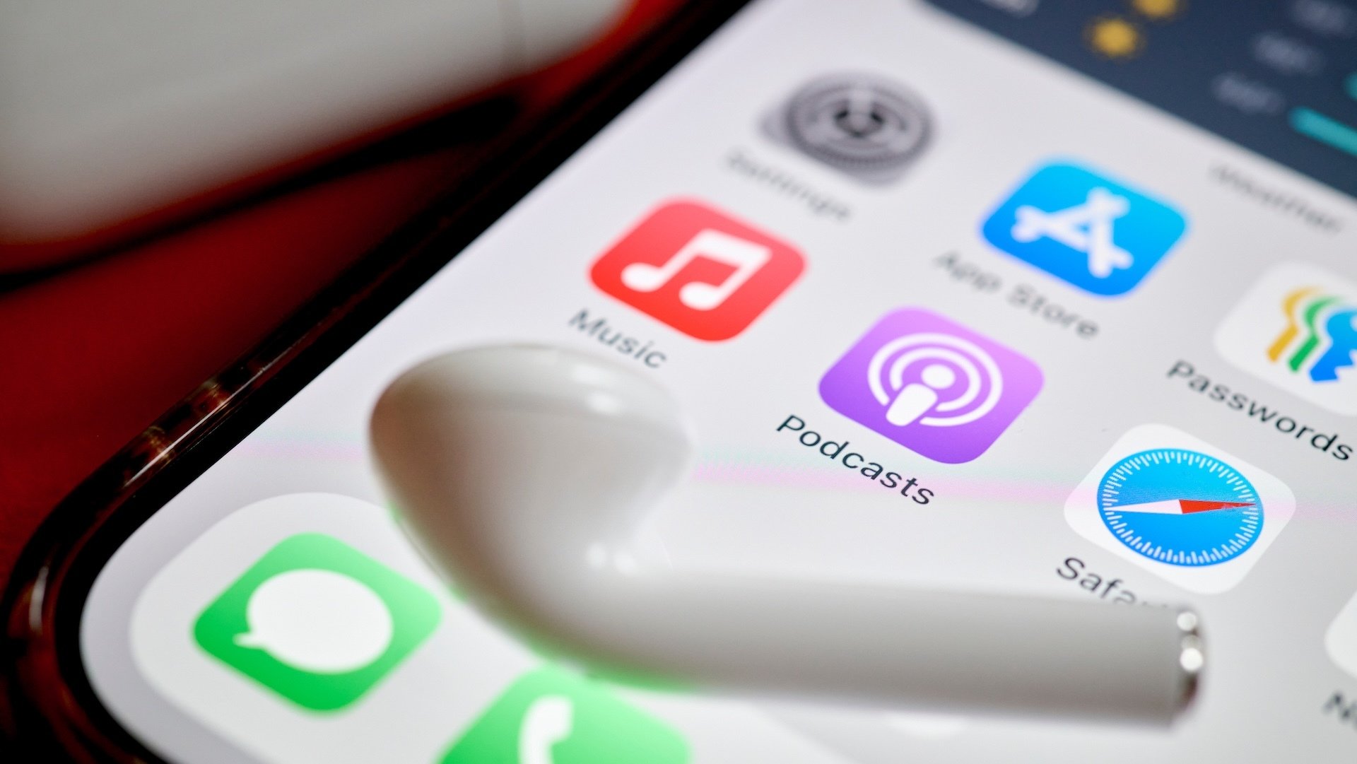 The Apple Music, Podcasts, and Safari apps on a smartphone.