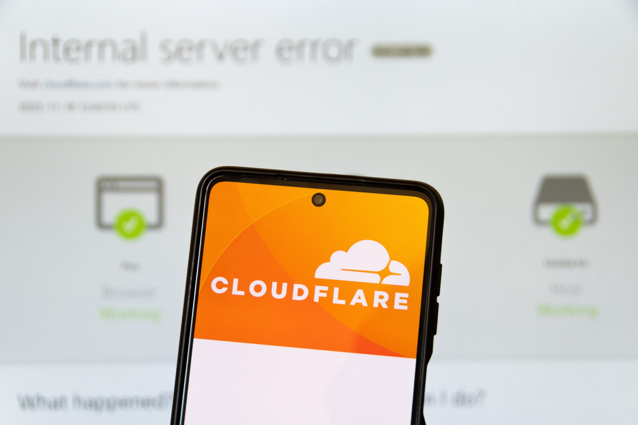 The Cloudflare logo appears on a smartphone screen and on the background on computer screen Internal server error
